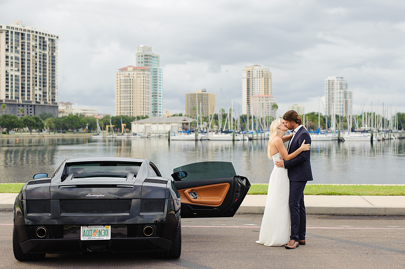 Luxurious City Engagement Session I Exotic Car, Flowy Strapless Ivory Dress and Fitted Suit I St. Pete Engagement Session by Sarah & Ben Photography