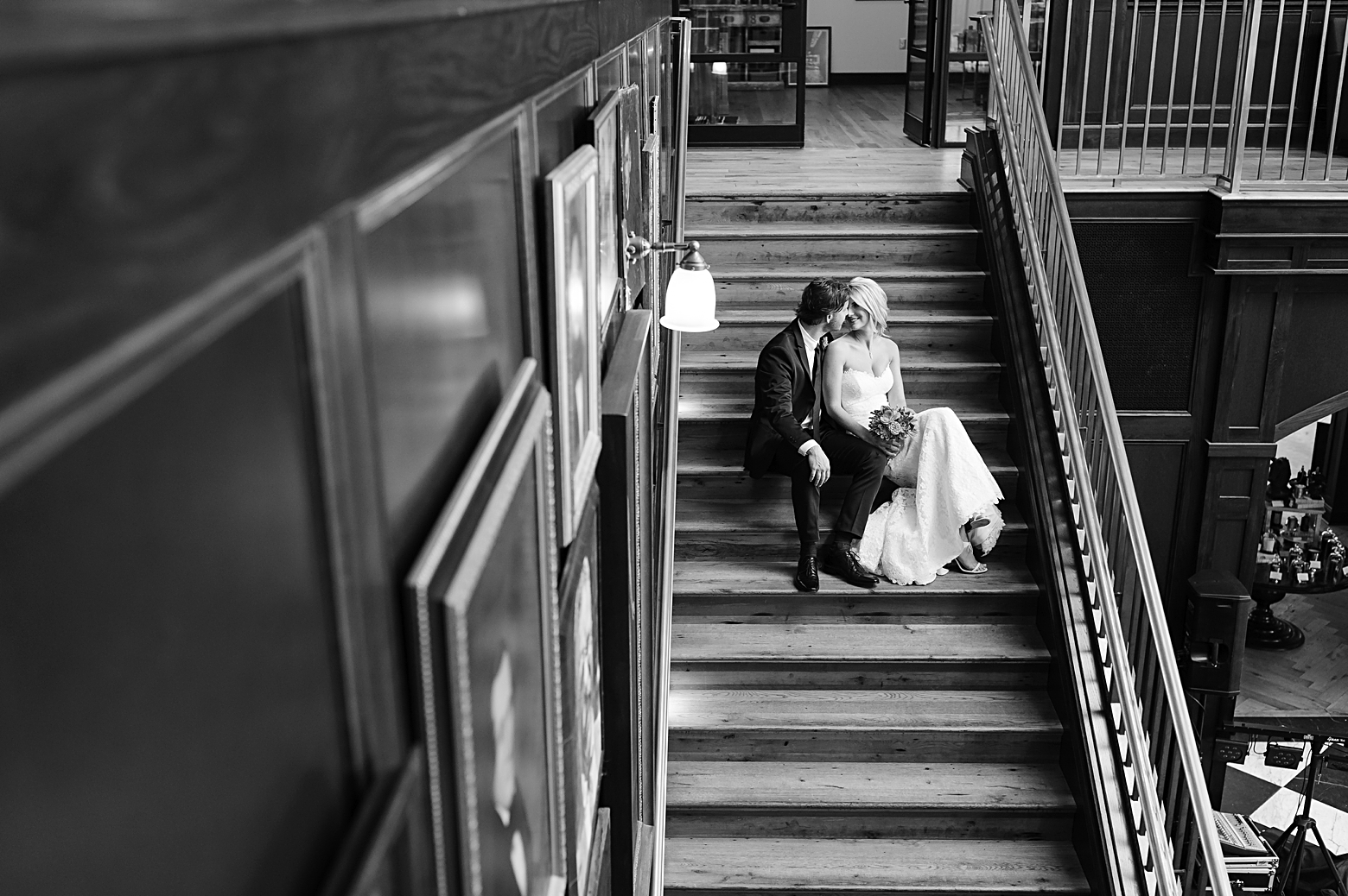 Groom and his Bride sit on the stairs of the Oxford Exchange in black and white photography by Sarah and Ben