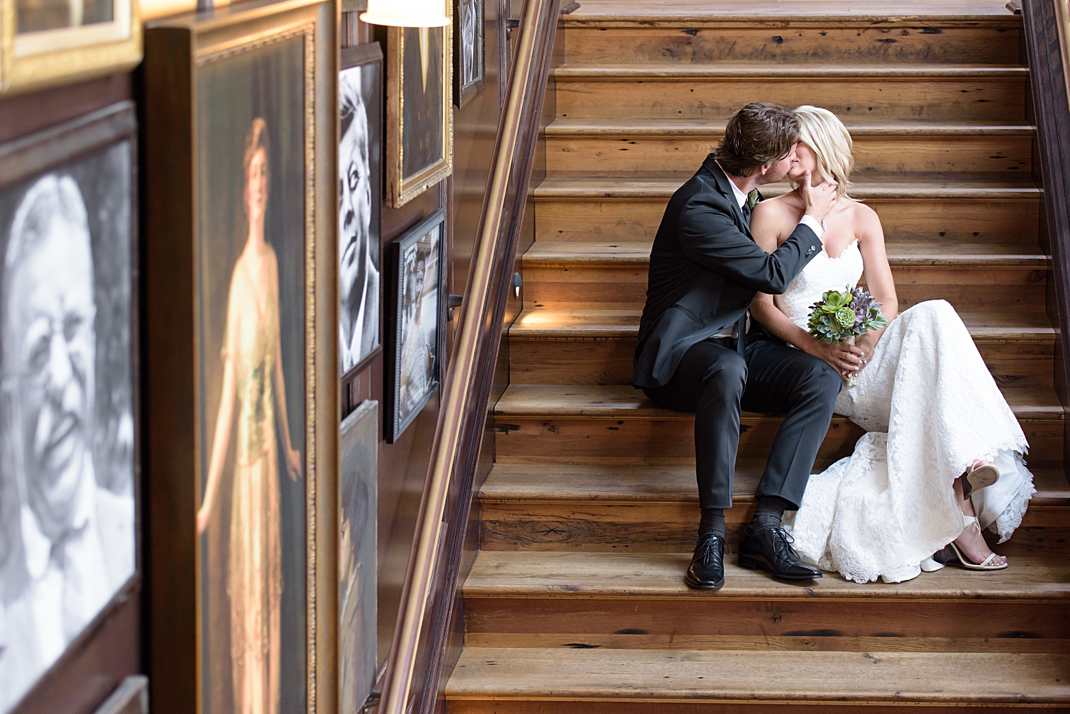 Groom kisses the Bride on the wooden steps of Oxford Exchange before their wedding day