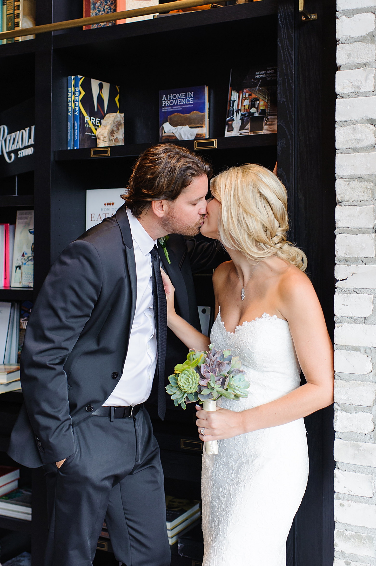 Bride and Groom kiss in the bookshop of Oxford Exchange after their wedding