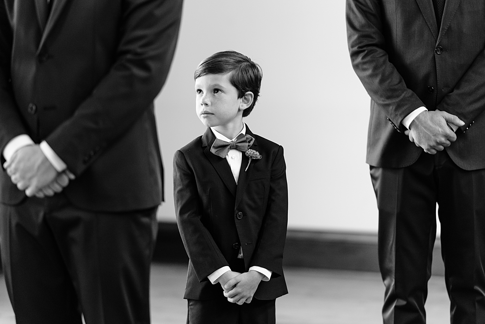 Groom's son looks at his Dad and future mom during their wedding ceremony