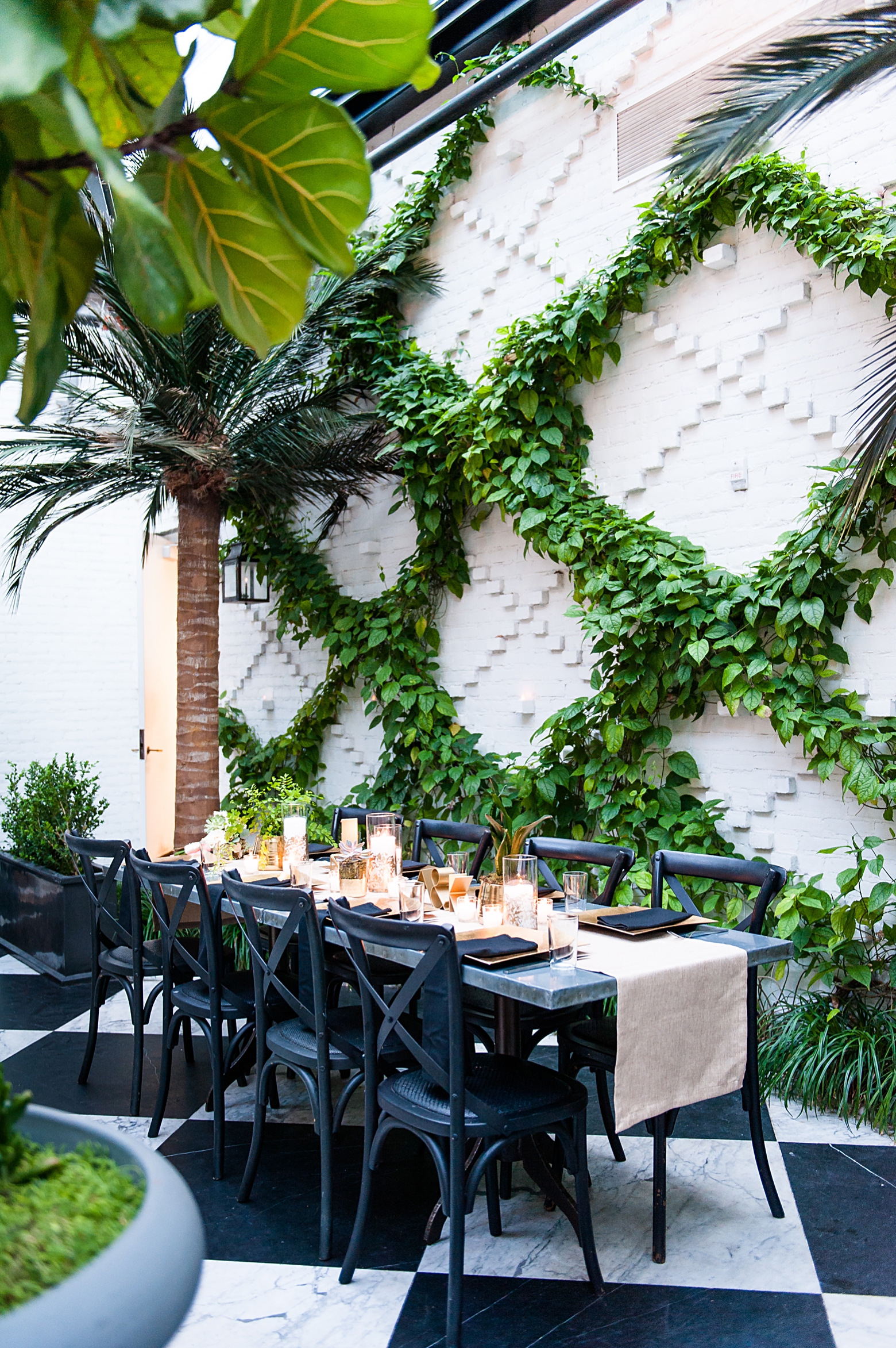 Wedding reception inside the Oxford Exchange atrium with white brick and greenery
