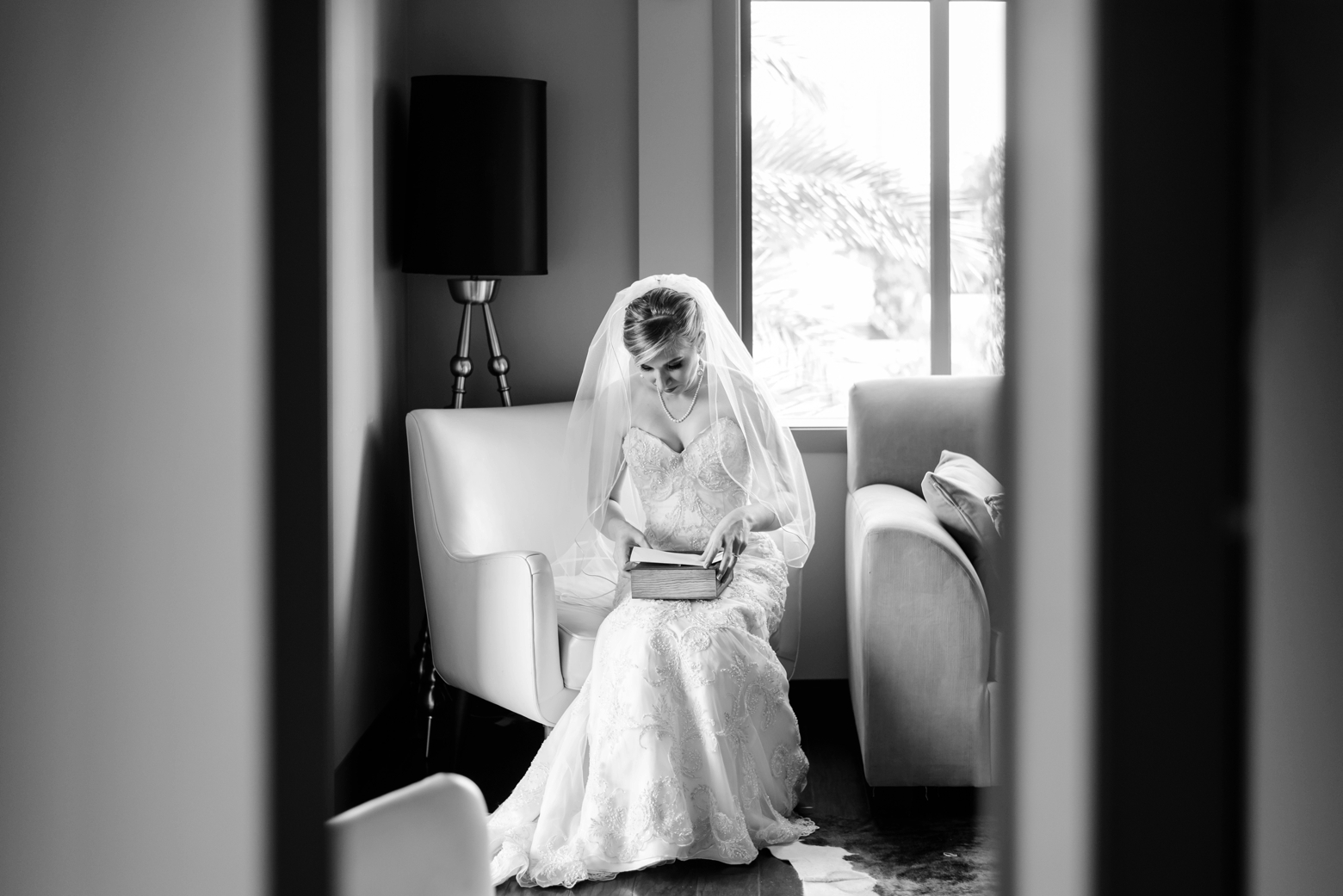 The Bride sits alone looking at her gift from the Groom