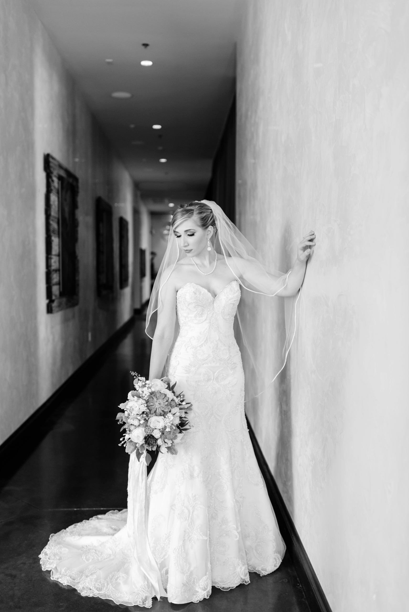 The Bride poses in the halls of the Epicurean Hotel holding her bouquet