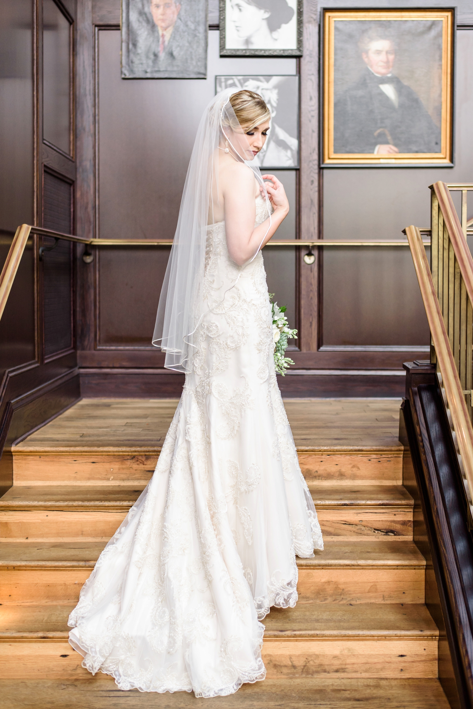 The Bride poses on the stairs before her Oxford Exchange wedding