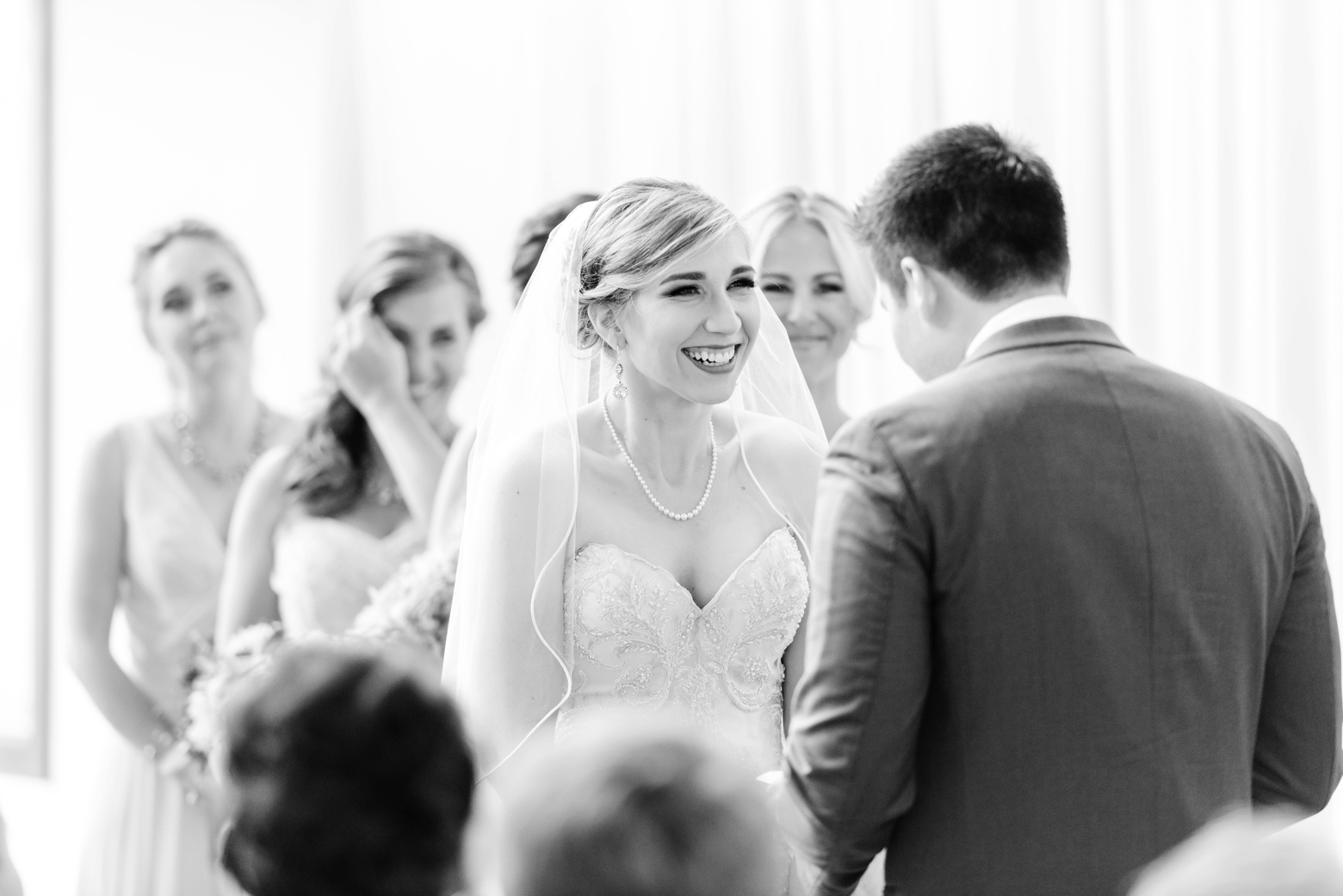 Bride smiling at her Groom during their wedding ceremony inside Oxford Exchange
