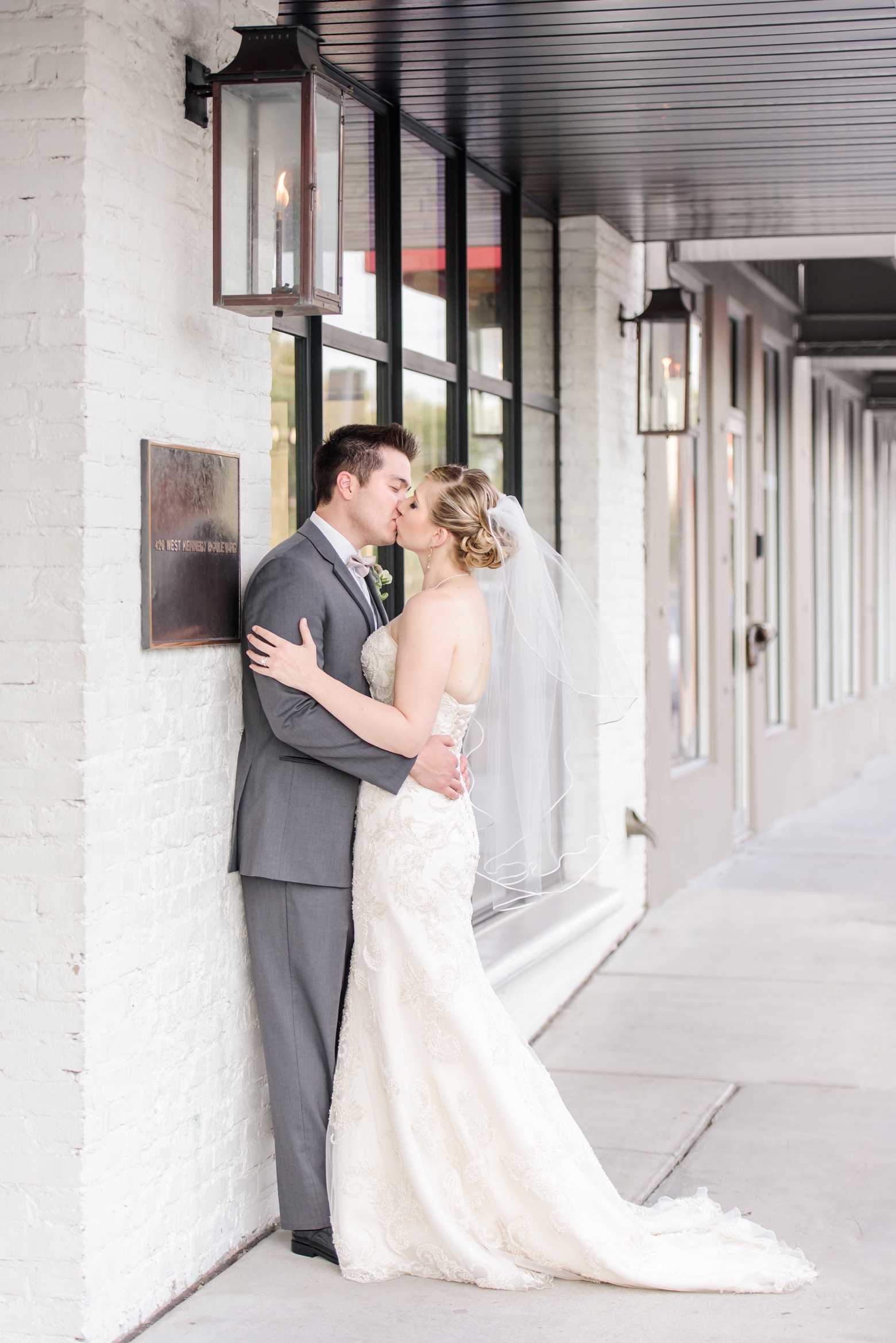 Bride and Groom kissing outside Oxford Exchange in Tampa, FL