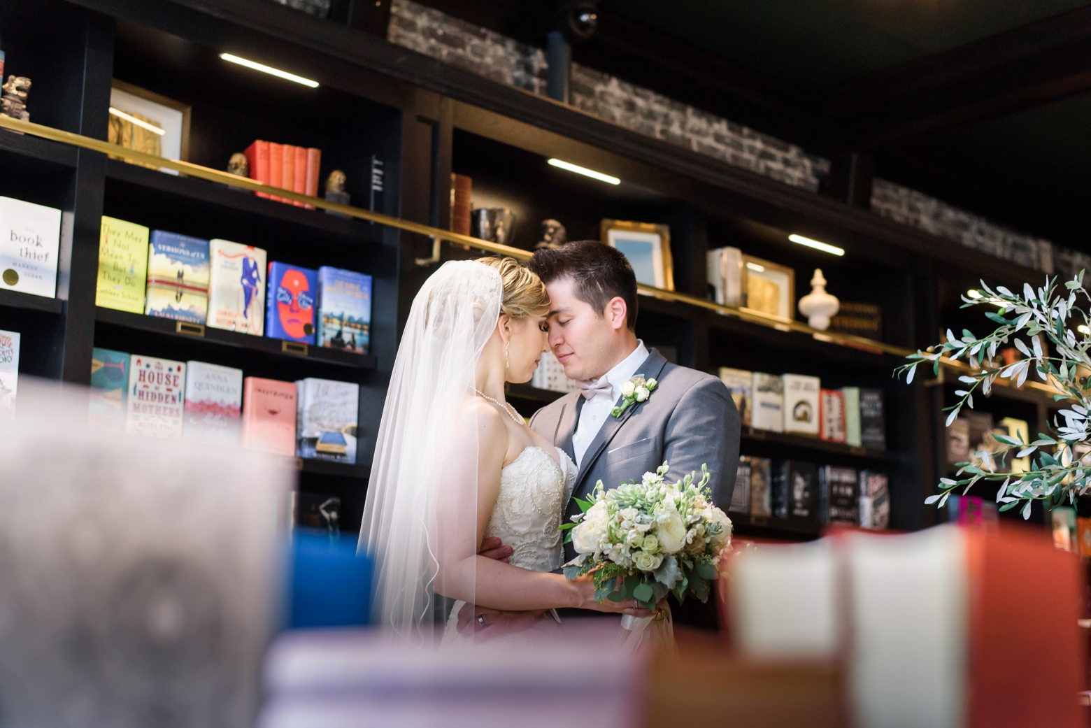 Bride and Groom share a quiet moment in the library of Oxford Exchange after their wedding