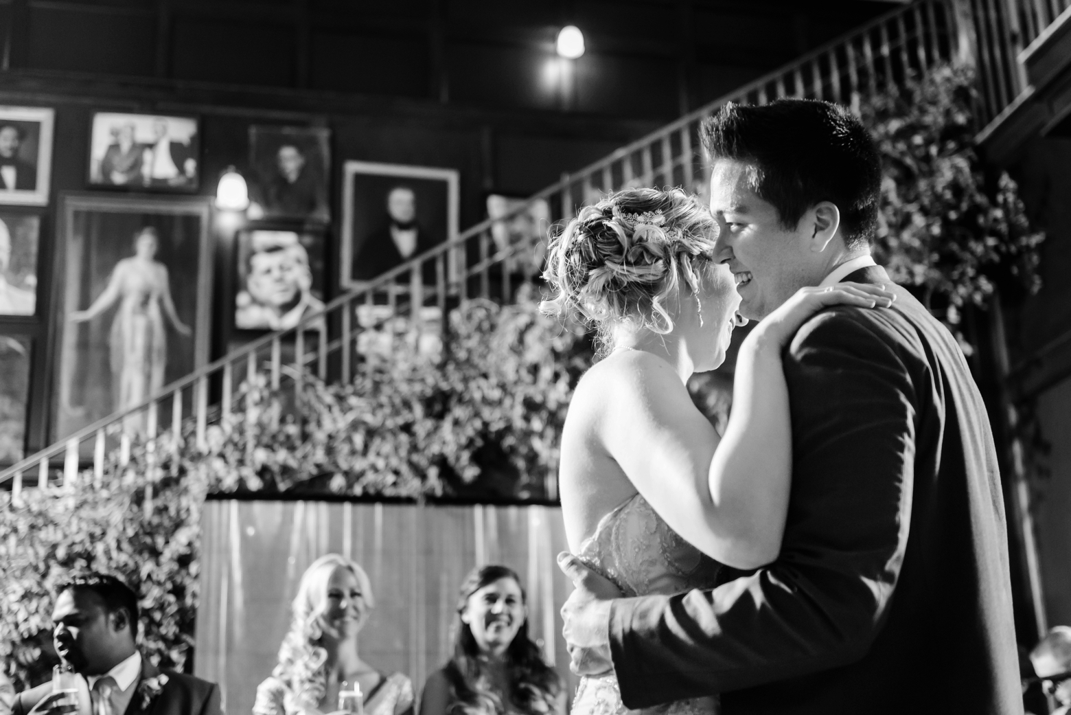 Bride and Groom dance together during their reception in classic black and white photography