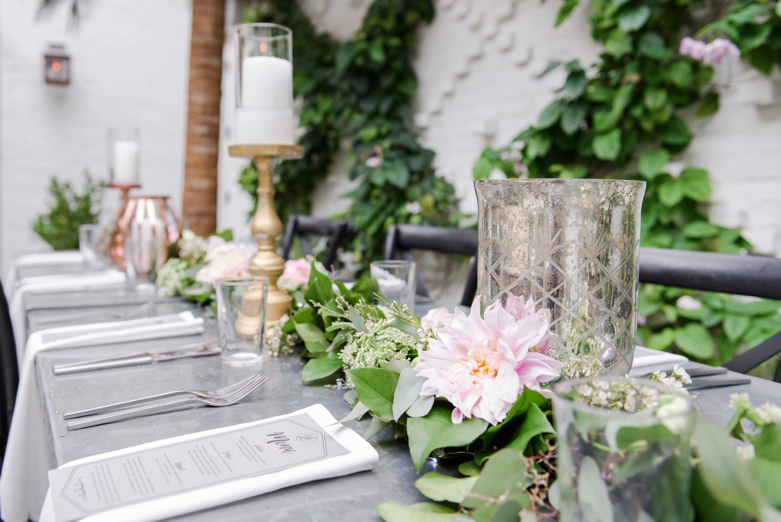 Table settings filled with florals and etched glass vases