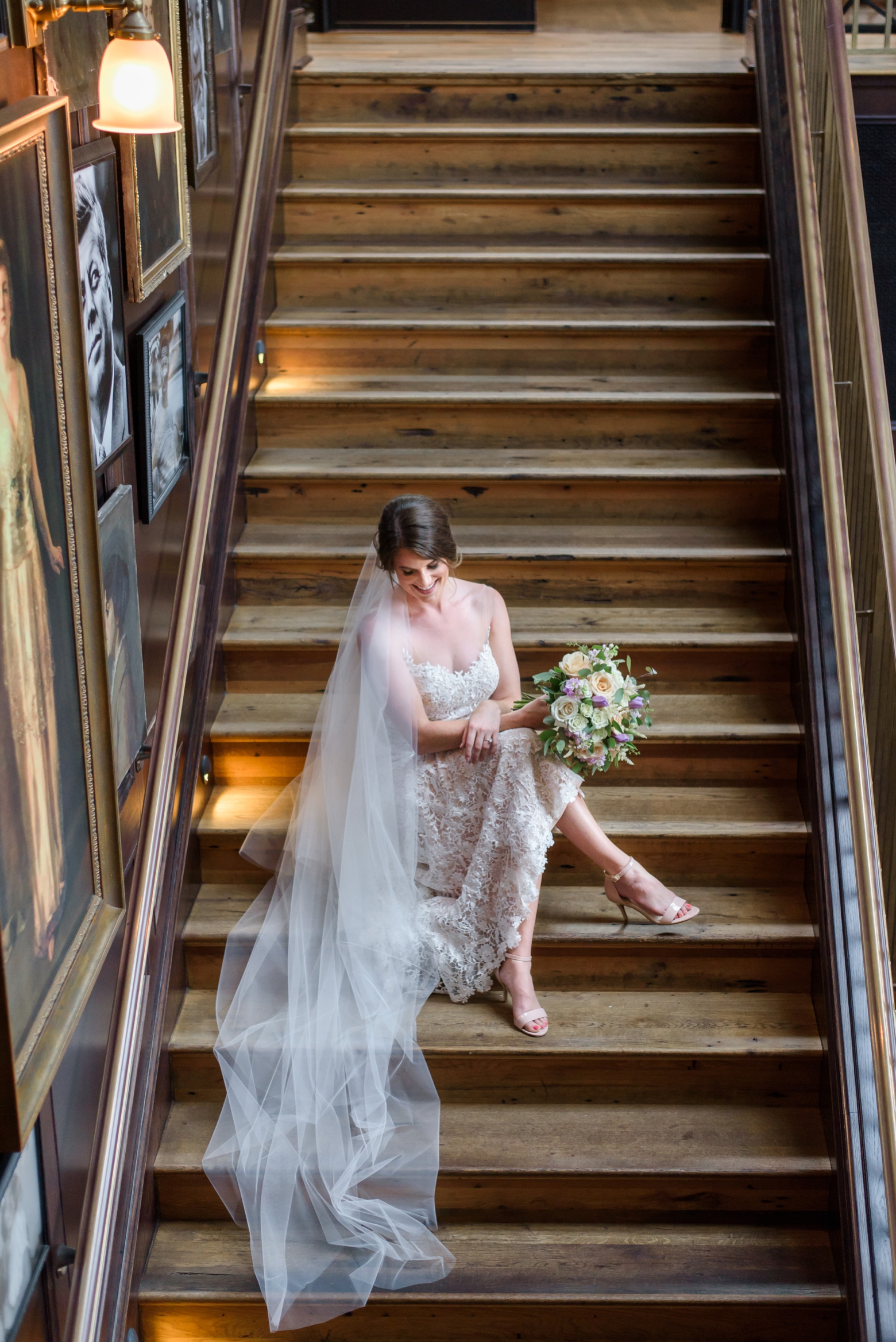 A bride sits on the steps during her Oxford Exchange bridal session