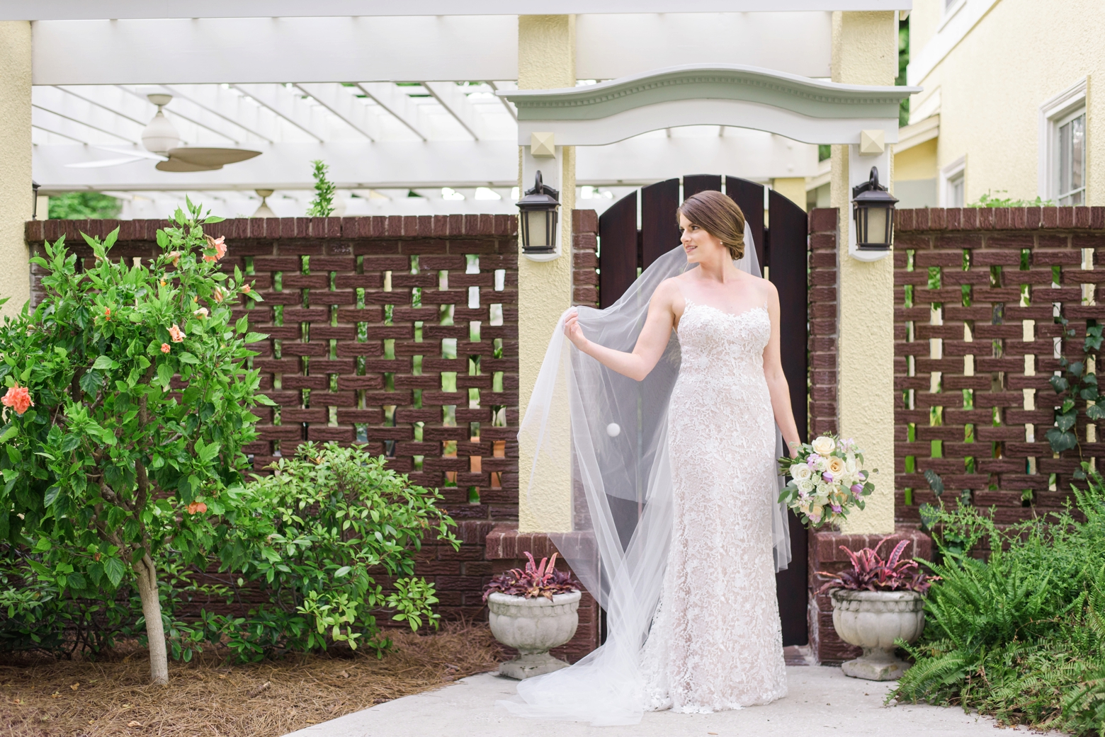 Bride stands outside her childhood home during her Tampa bridal session