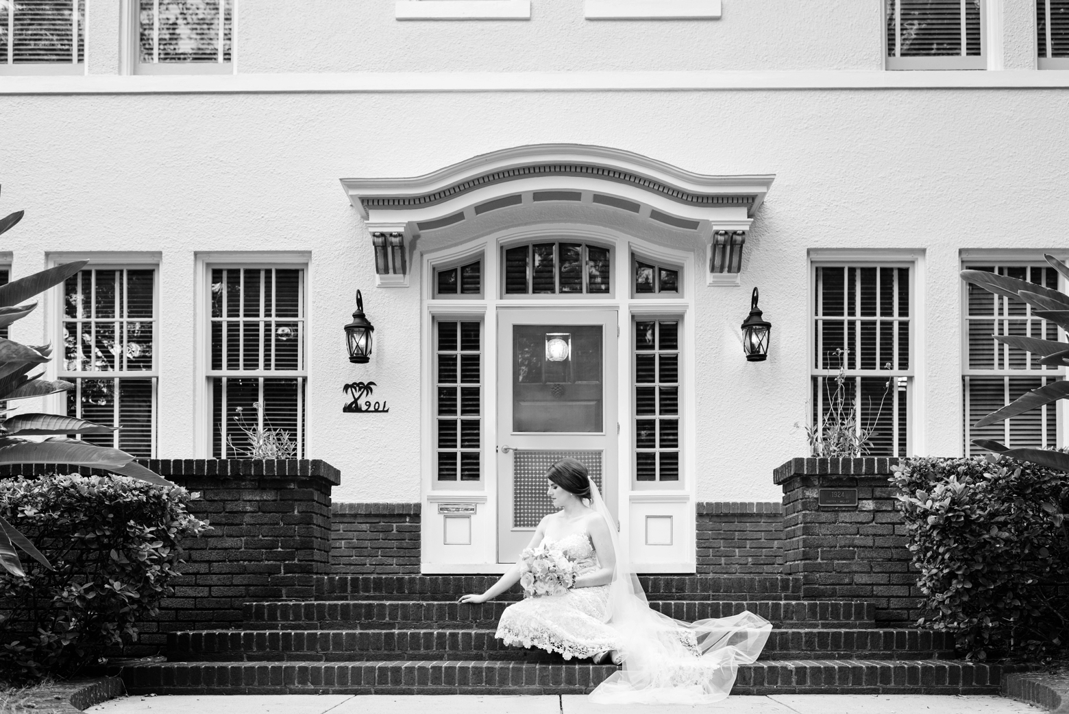 Bride sits on the steps of her Tampa Florida home during her bridal session