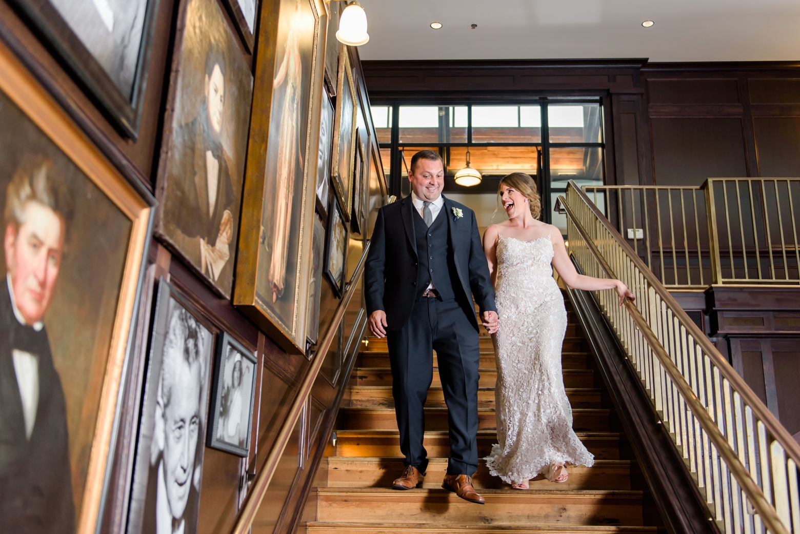 Bride and Groom descend a staircase in Tampa to their oxford exchange wedding reception