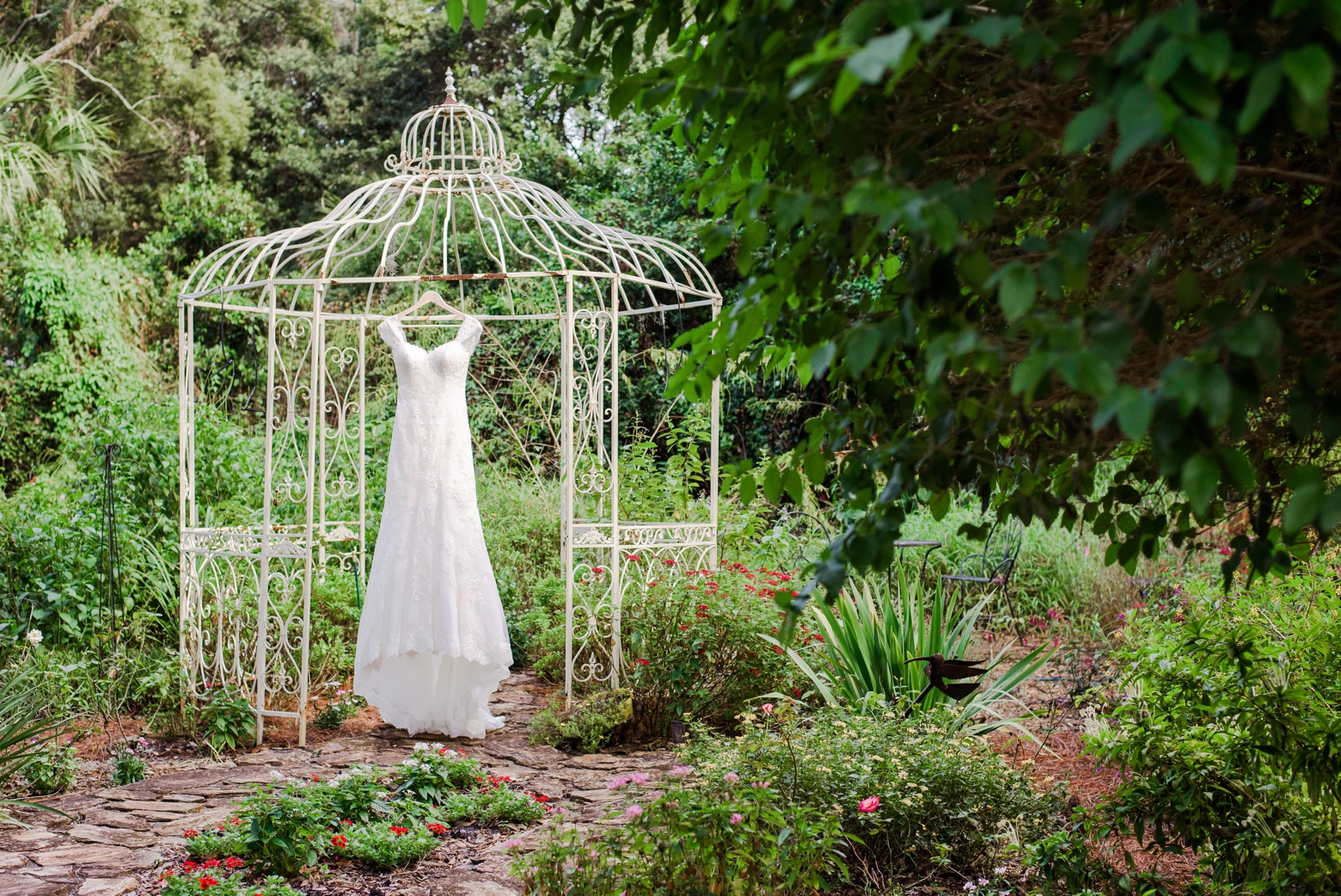 The Wedding Dress hangs in the gardens of Cross Creek Ranch