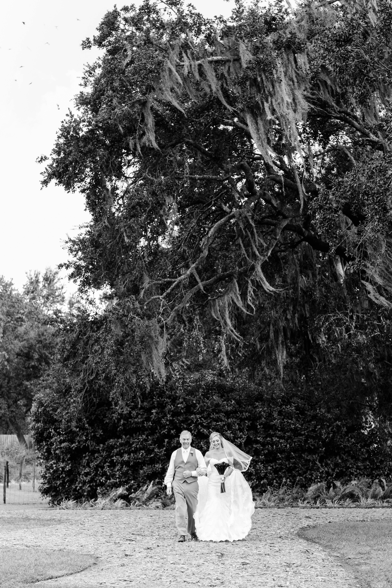 The Bride and her Father walk toward the ceremony during the Cross Creek Ranch wedding day
