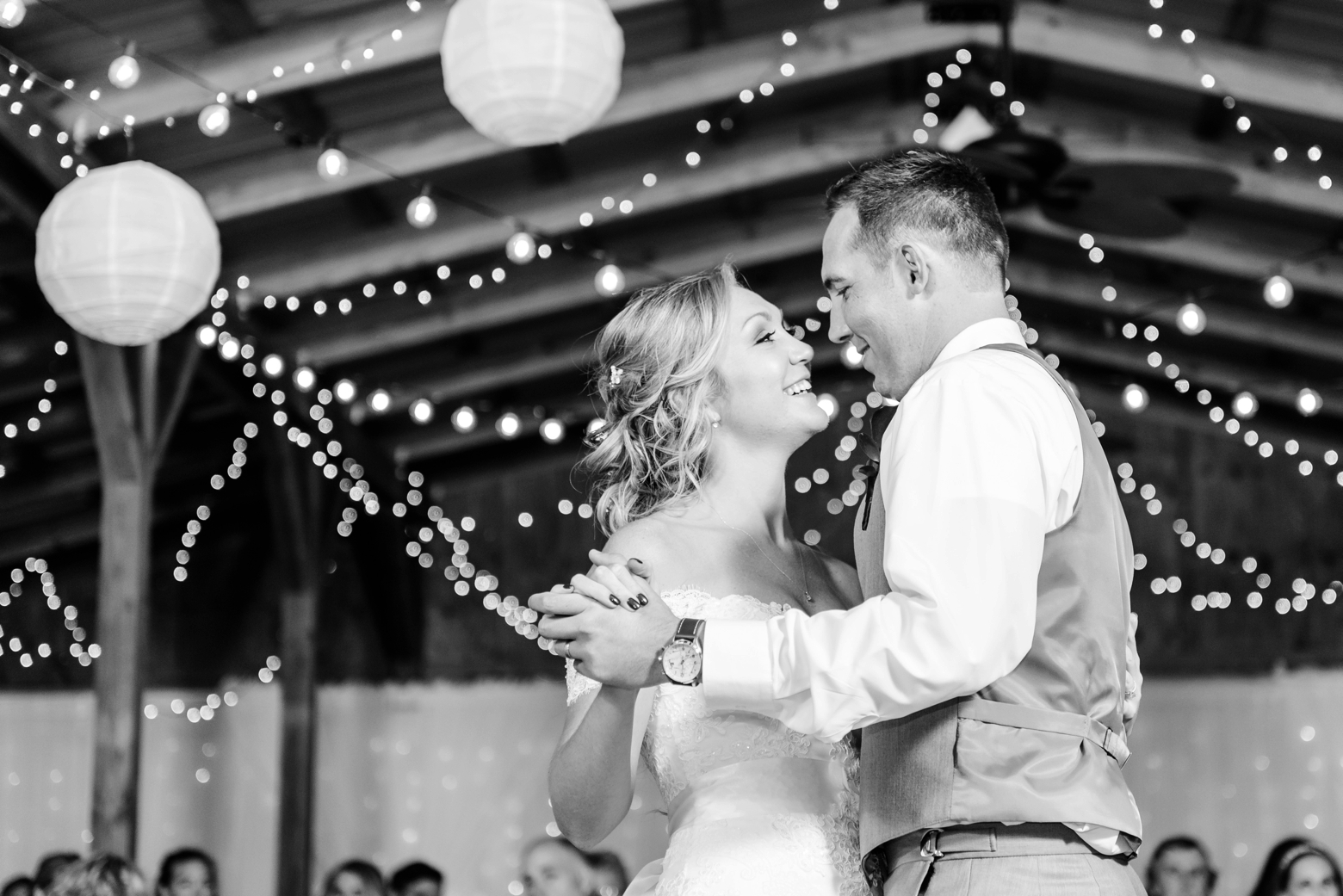 Bride and Groom share a first dance under all the twinkle lights during the reception of their Cross Creek Ranch wedding day
