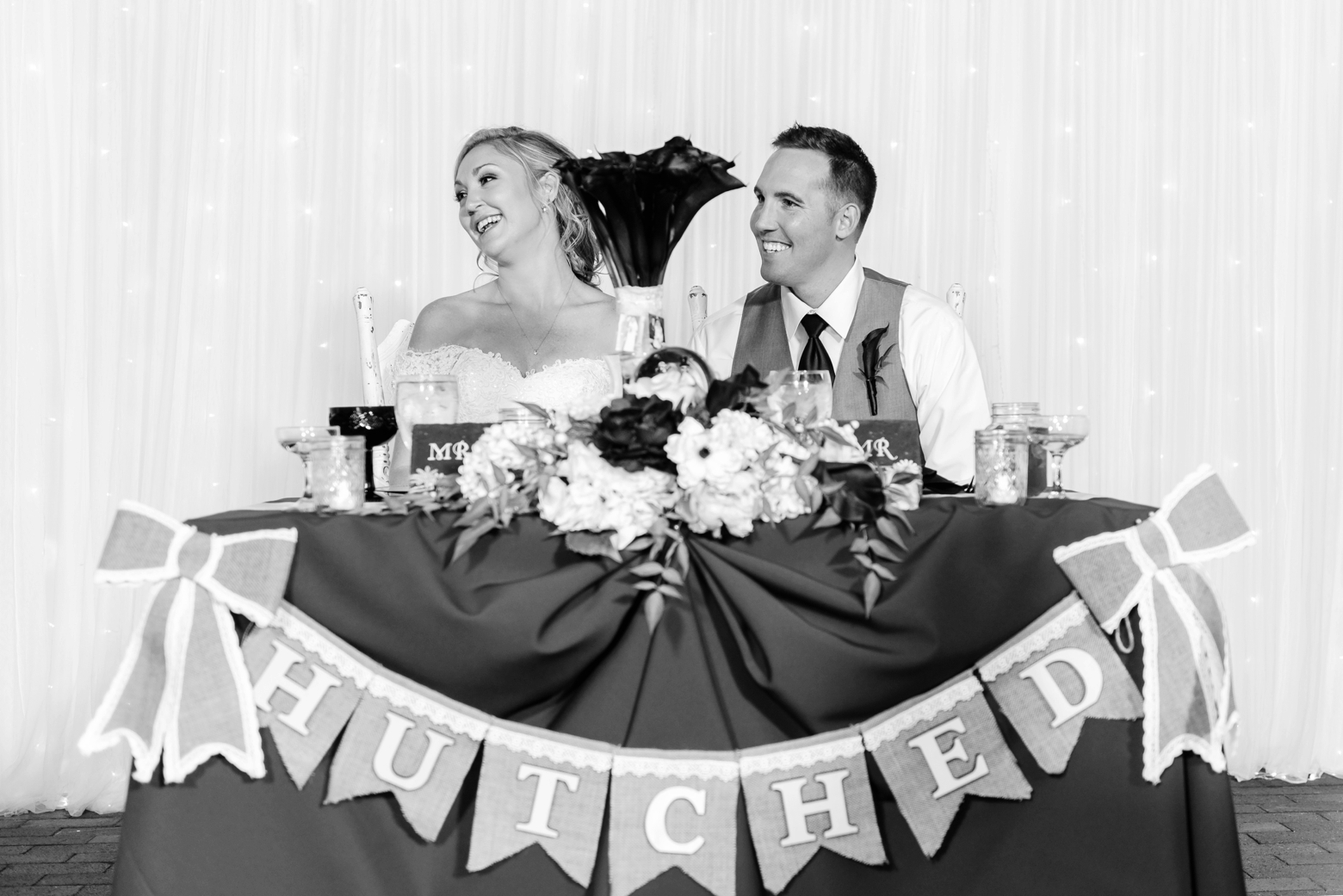 Bride and Groom laugh during toasts given by members of the wedding party