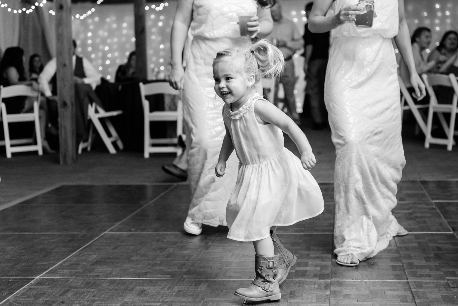 Child runs across the dance floor during a Cross Creek Ranch reception party