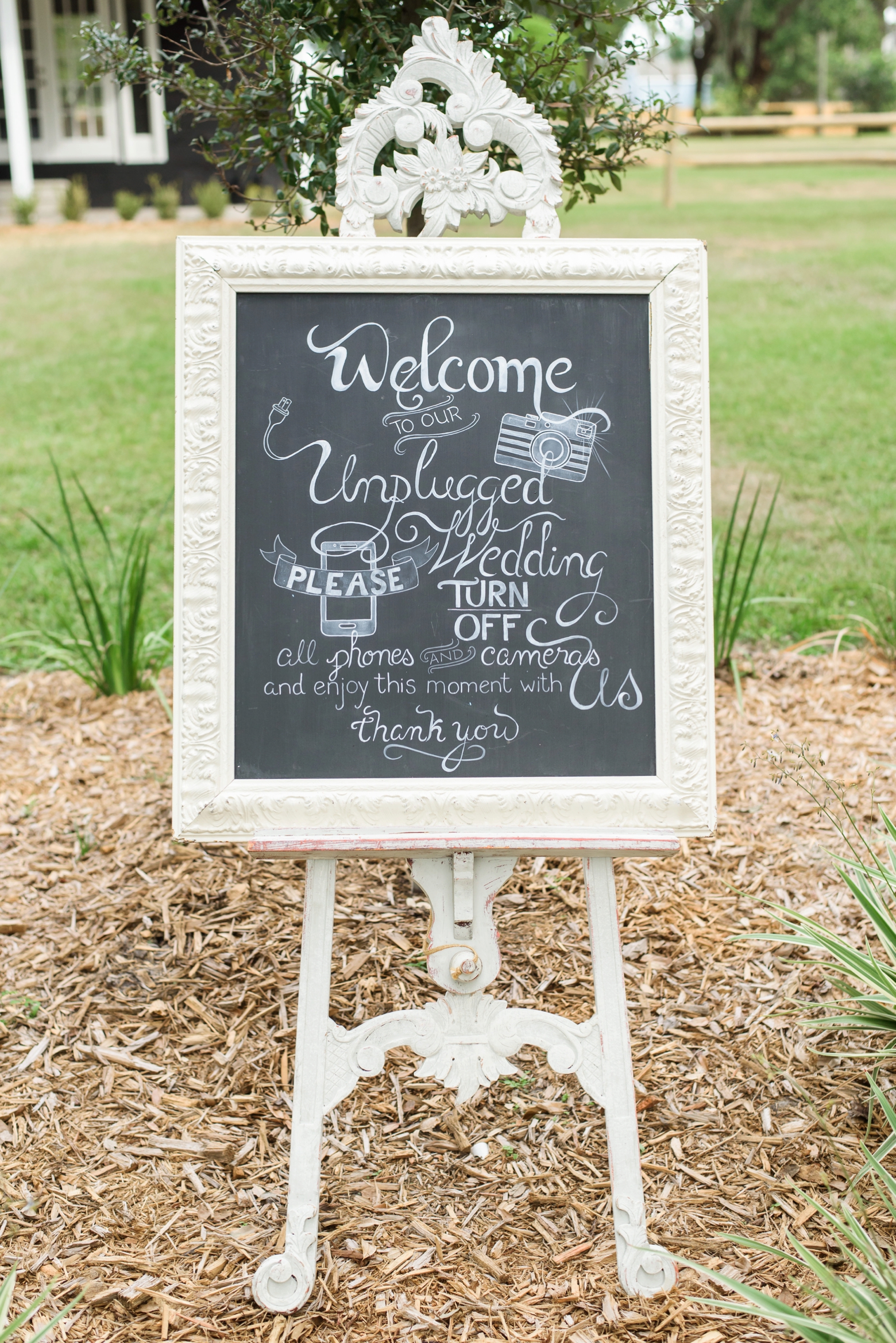 Chalkboard sign outside the cross creek wedding ceremony asking guests to turn off their cell phones
