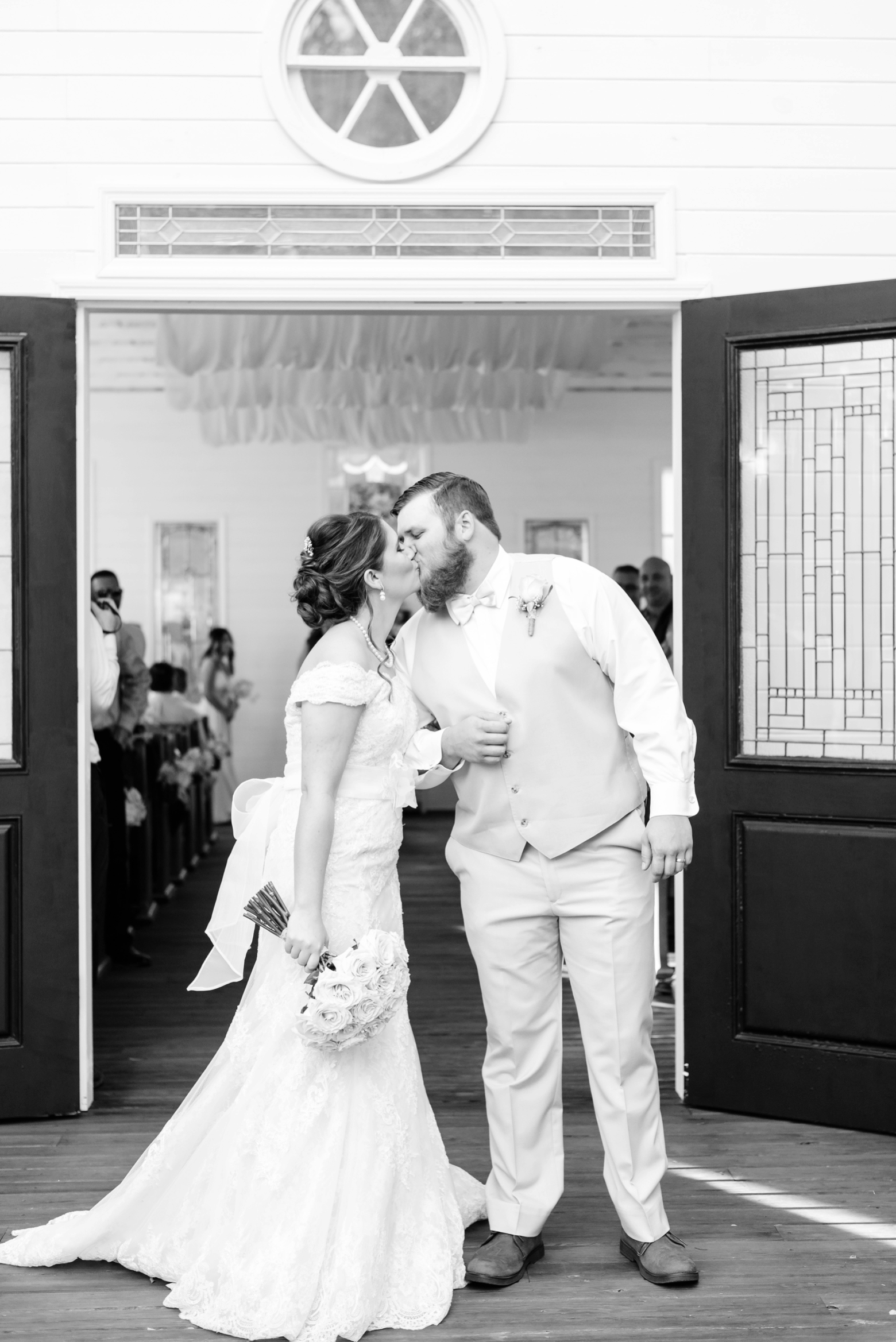 The Bride and Groom kiss after leaving the chapel after their cross creek wedding ceremony