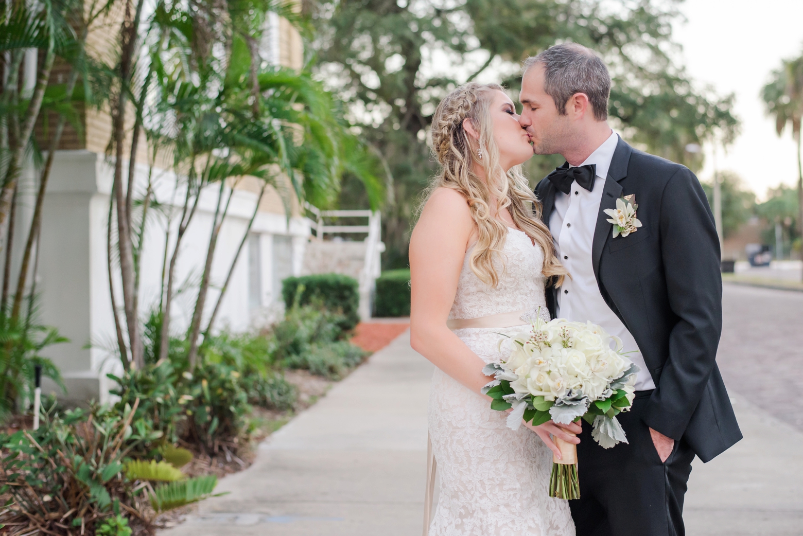 Bride and Groom share a kiss on the palm lined streets of South Tampa, FL