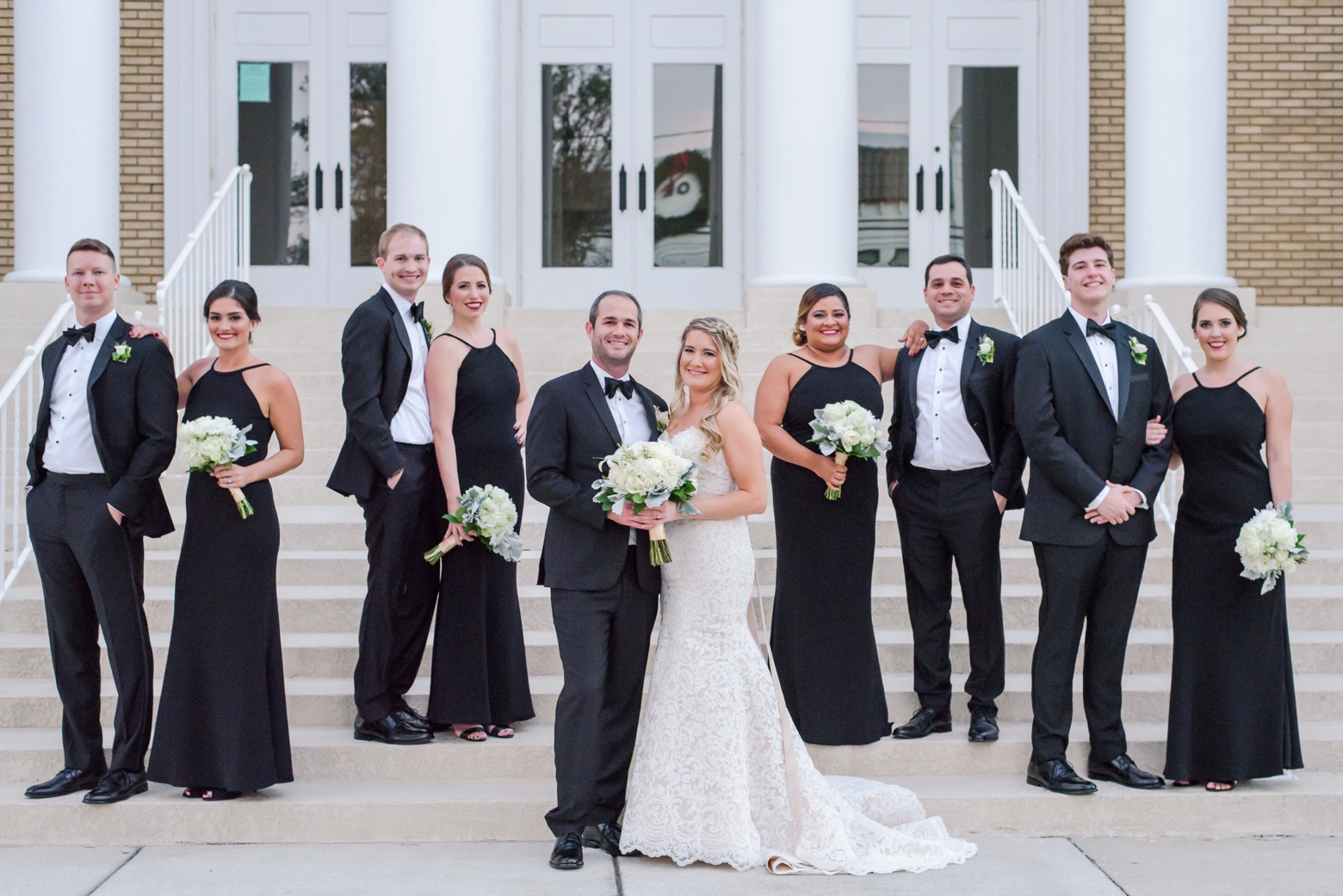 The Bridal Party pose on the steps of a building in Downtown Tampa, FL