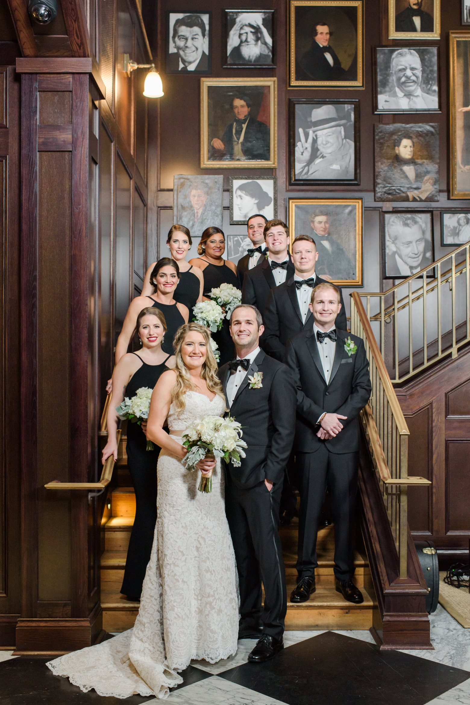 The Wedding Party pose for a formal photo on the steps inside the Oxford Exchange in Tampa, FL