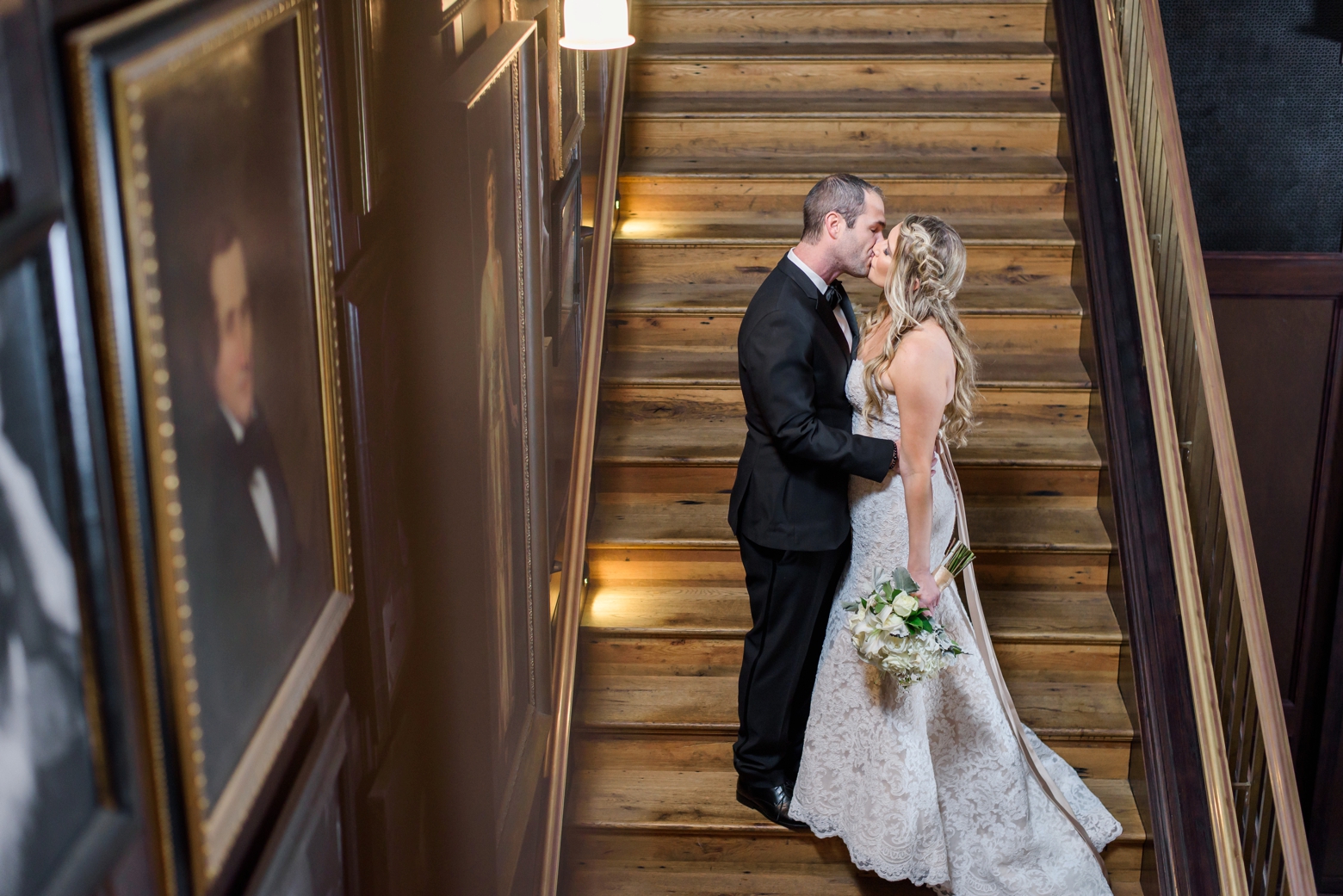 Bride and Groom kiss on the steps inside the Oxford Exchange by Sarah and Ben Photography