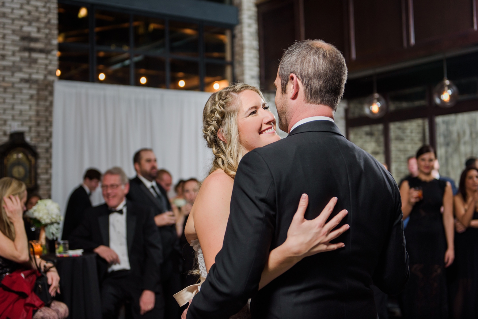 Bride shares a loving glance at the Groom during their first dance by Sarah & Ben Photography