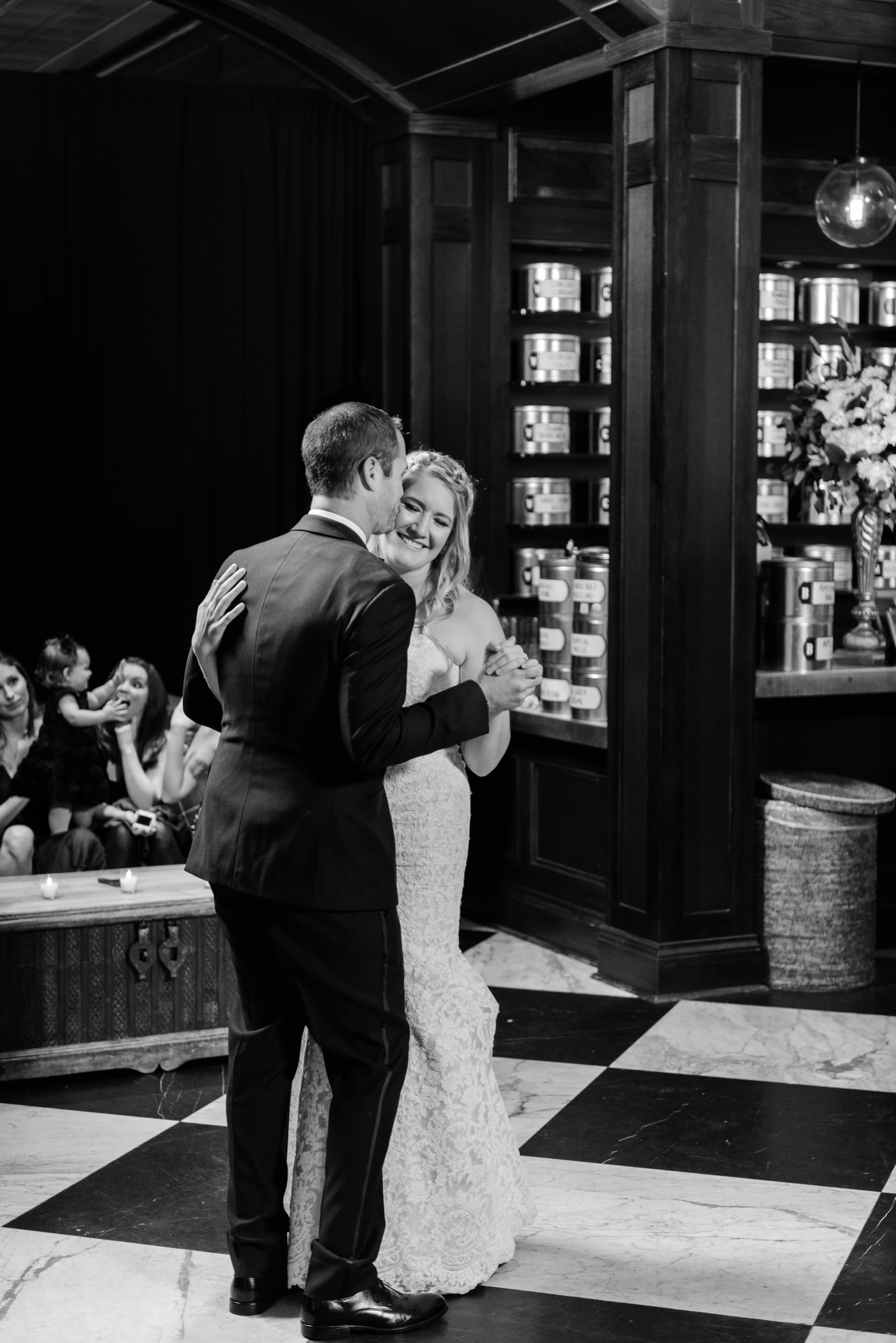 Groom kisses the Bride on the cheek during their first dance