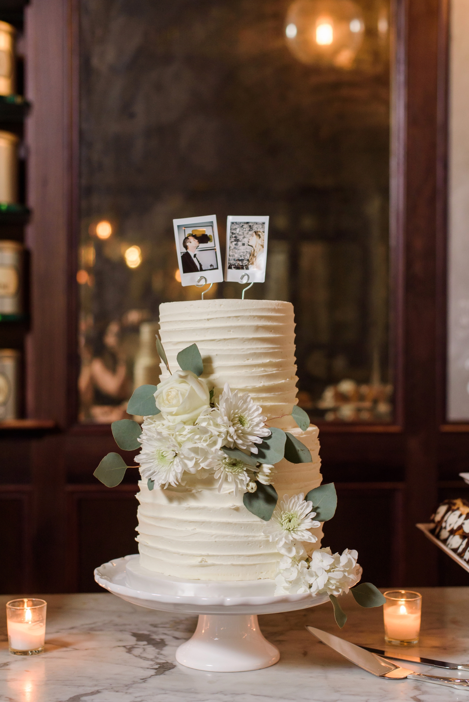 The wedding cake with insta film selfies of the Bride and Groom as cake toppers