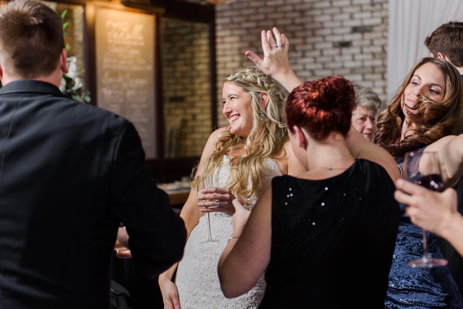 Bride hits the dance floor with her wedding guests by Sarah and Ben Photography