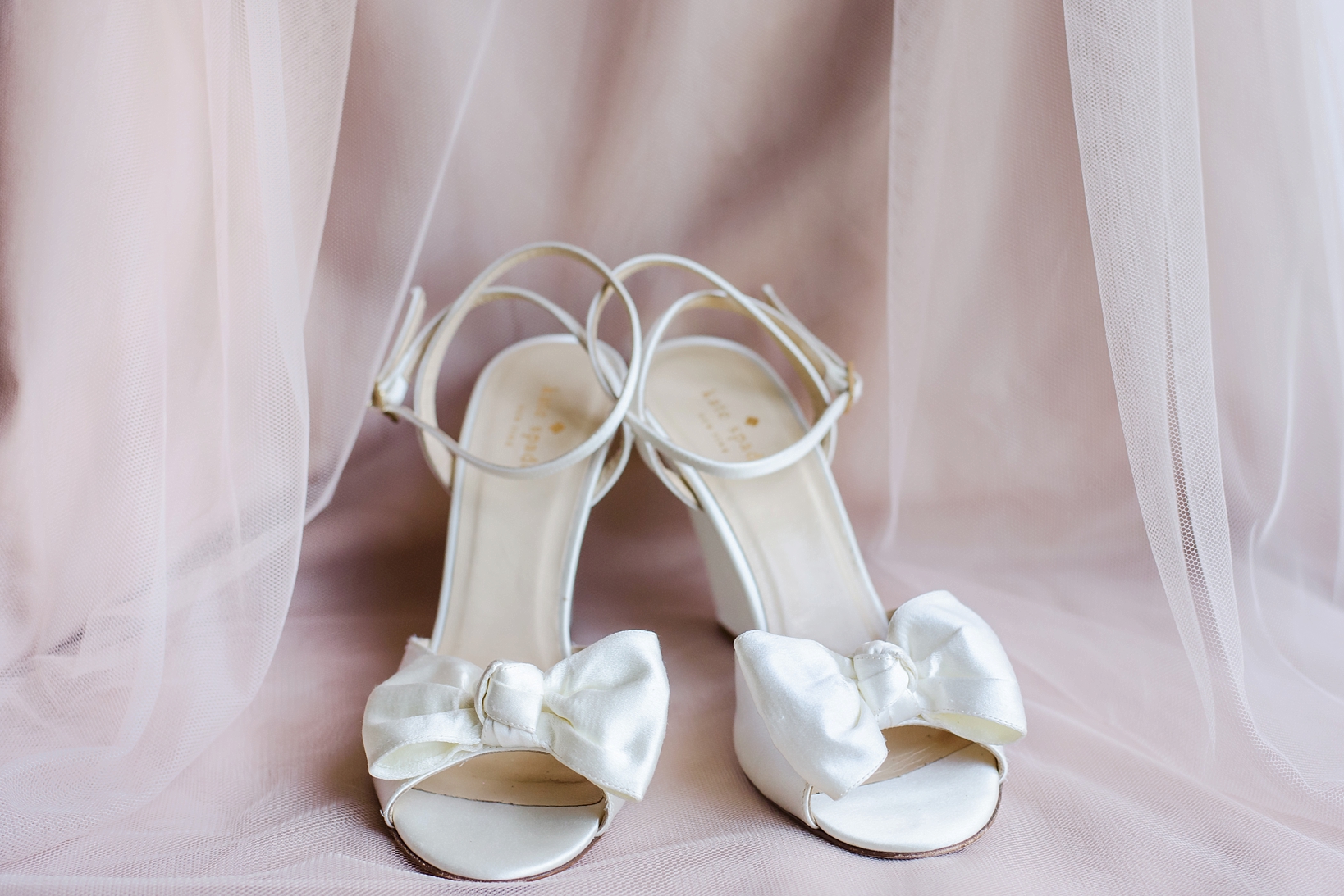 Kate Spade bridal shoes against a blush gown