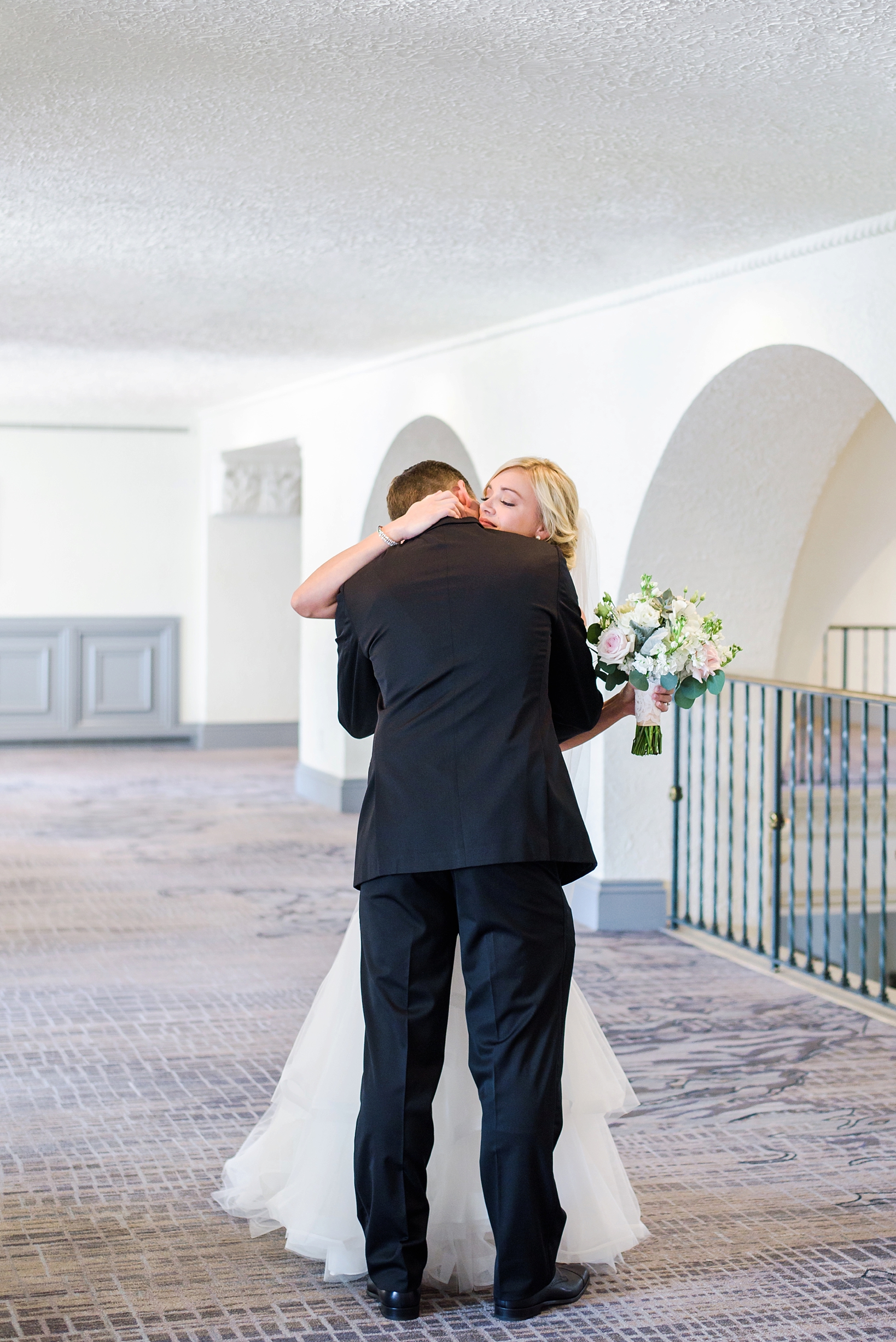 Bride and groom hug for the first time as they see each other on their wedding day.