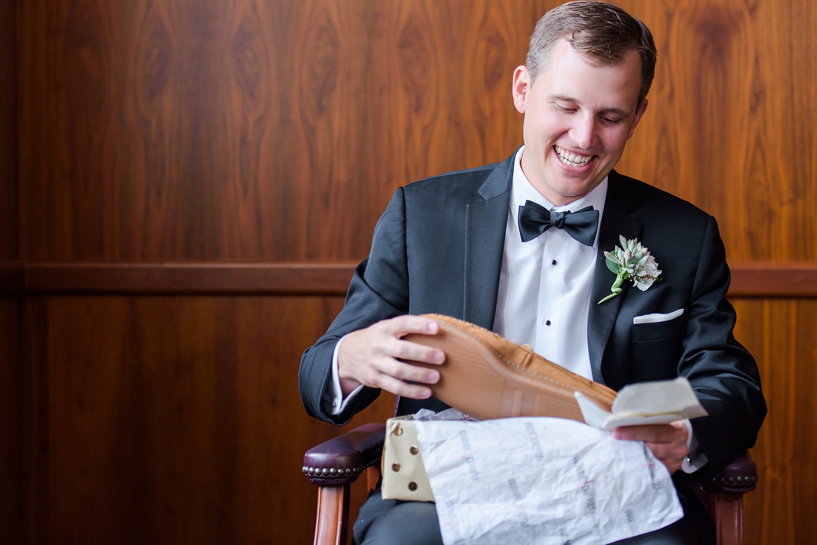 Groom opening his present from his bride on his wedding day