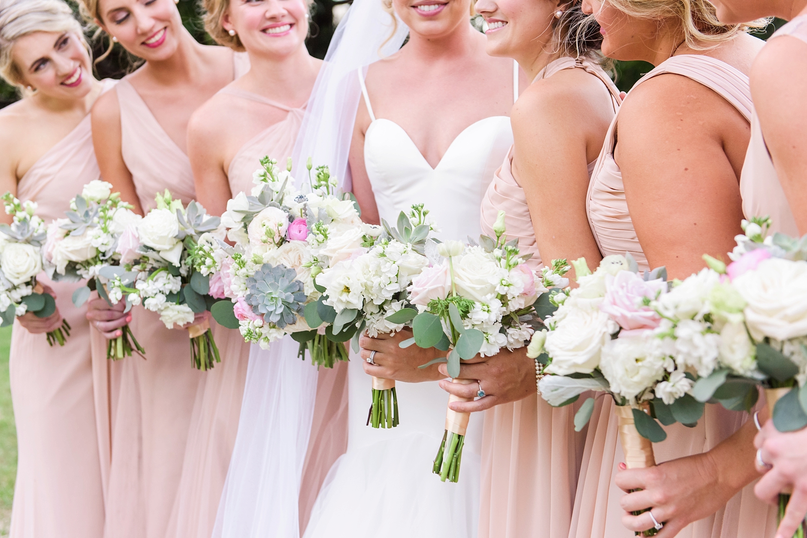 Bridal bouquets against the blush dresses of the bridal party