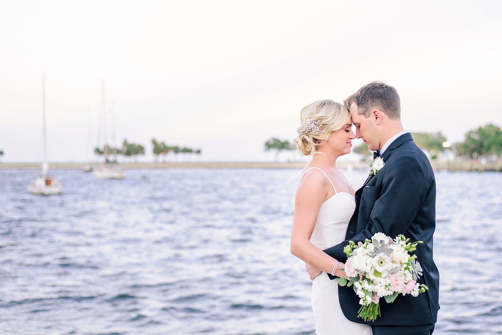Bride and groom against a watery background in St. Petersburg, FL