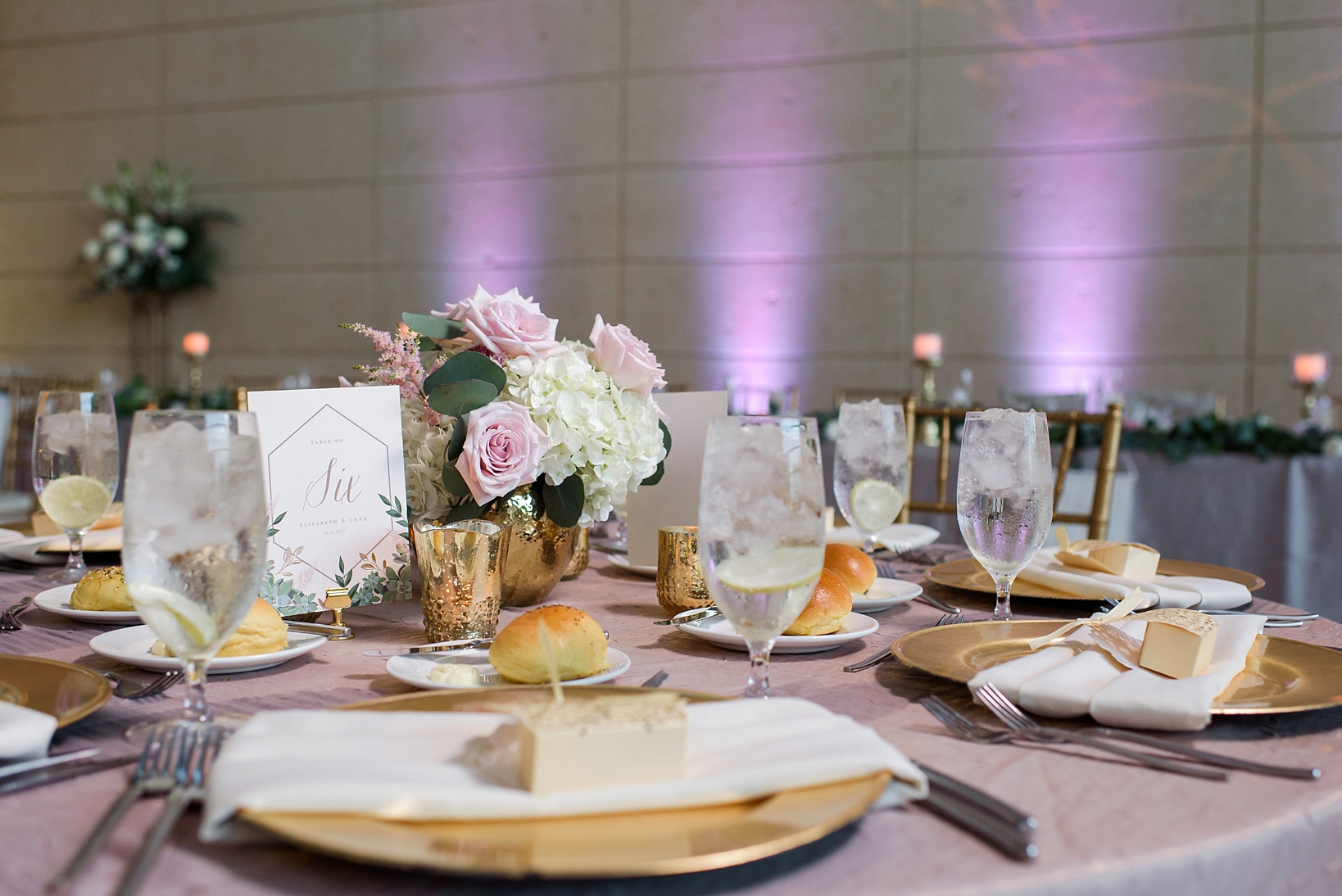 Wedding Reception details with purple uplighting and gold accents