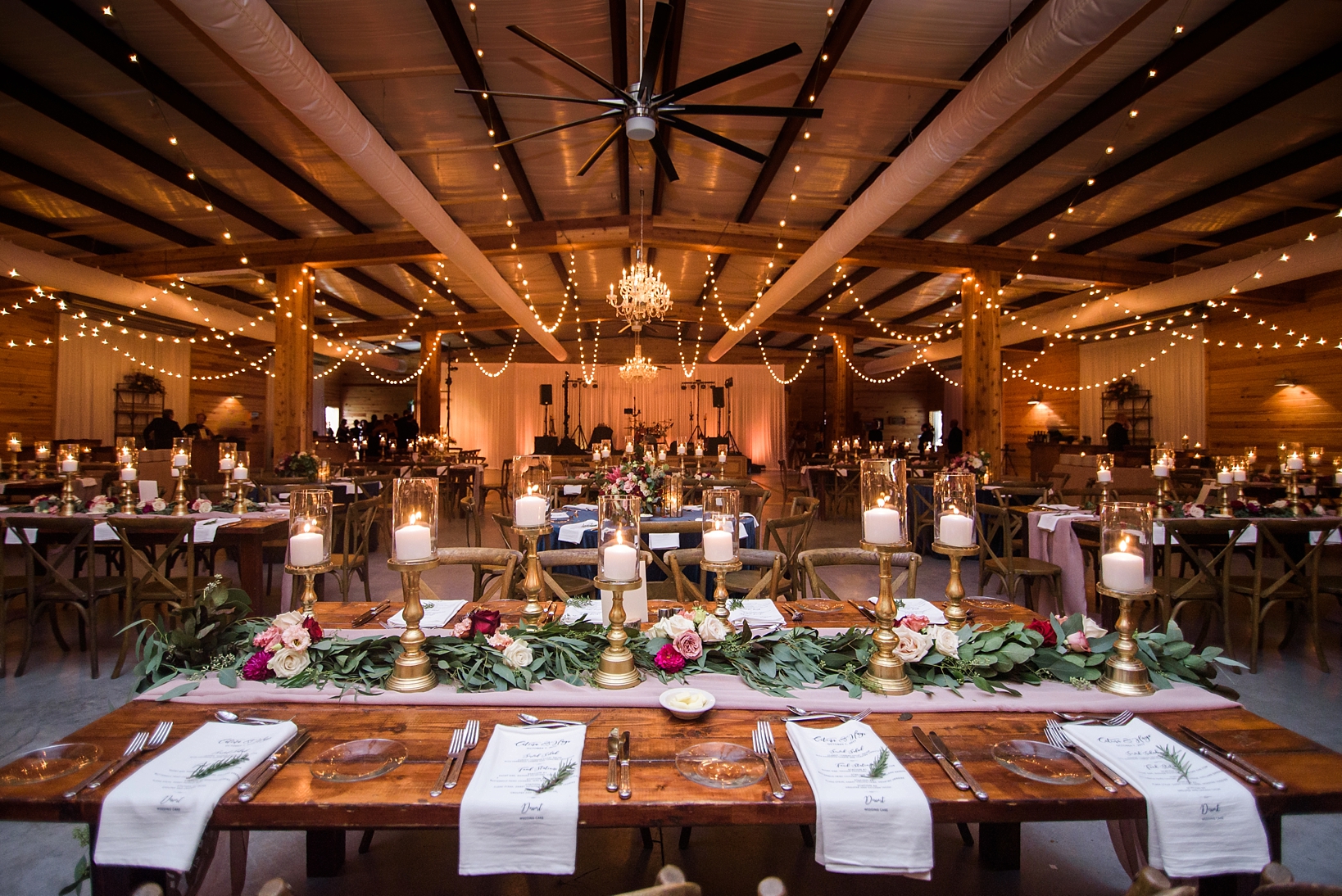 Linen printed menus along a farm table surrounded by glow lights