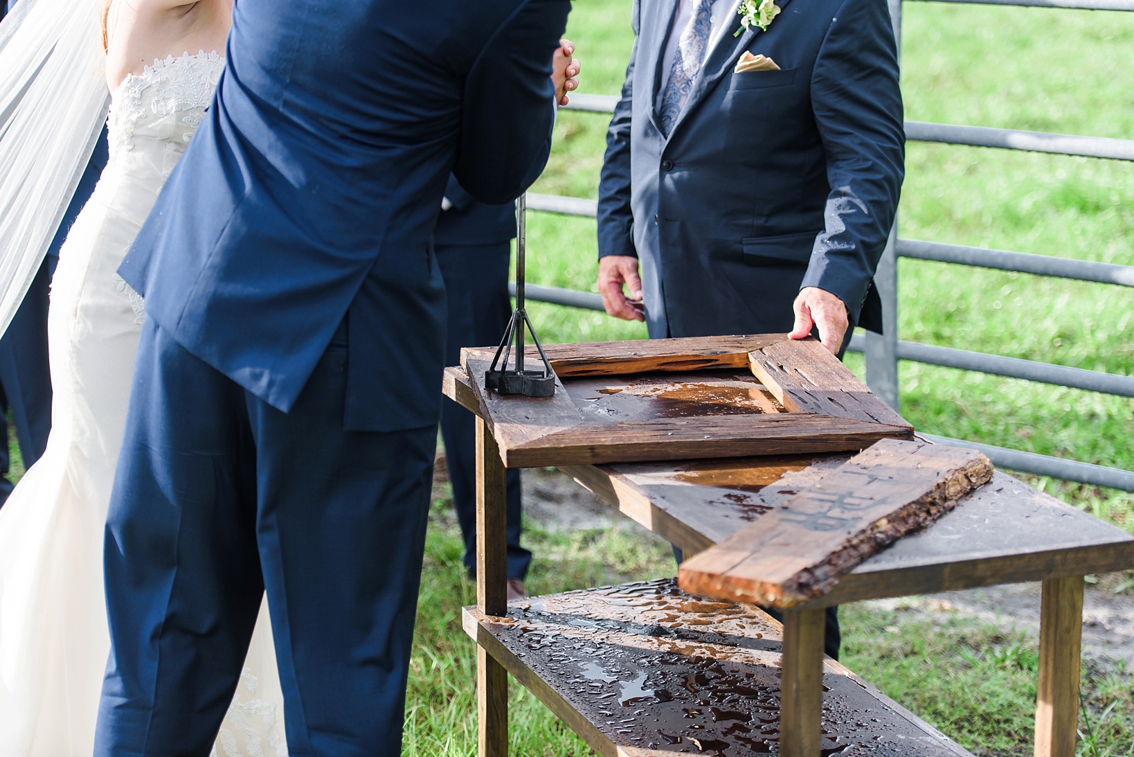 Bride and Groom brand their family logo into a wooden frame