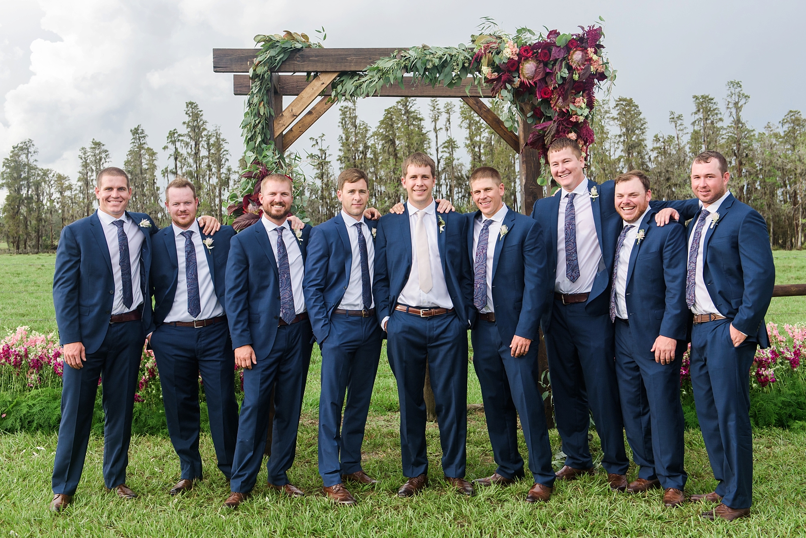 Groom and his groomsmen at the wedding arch
