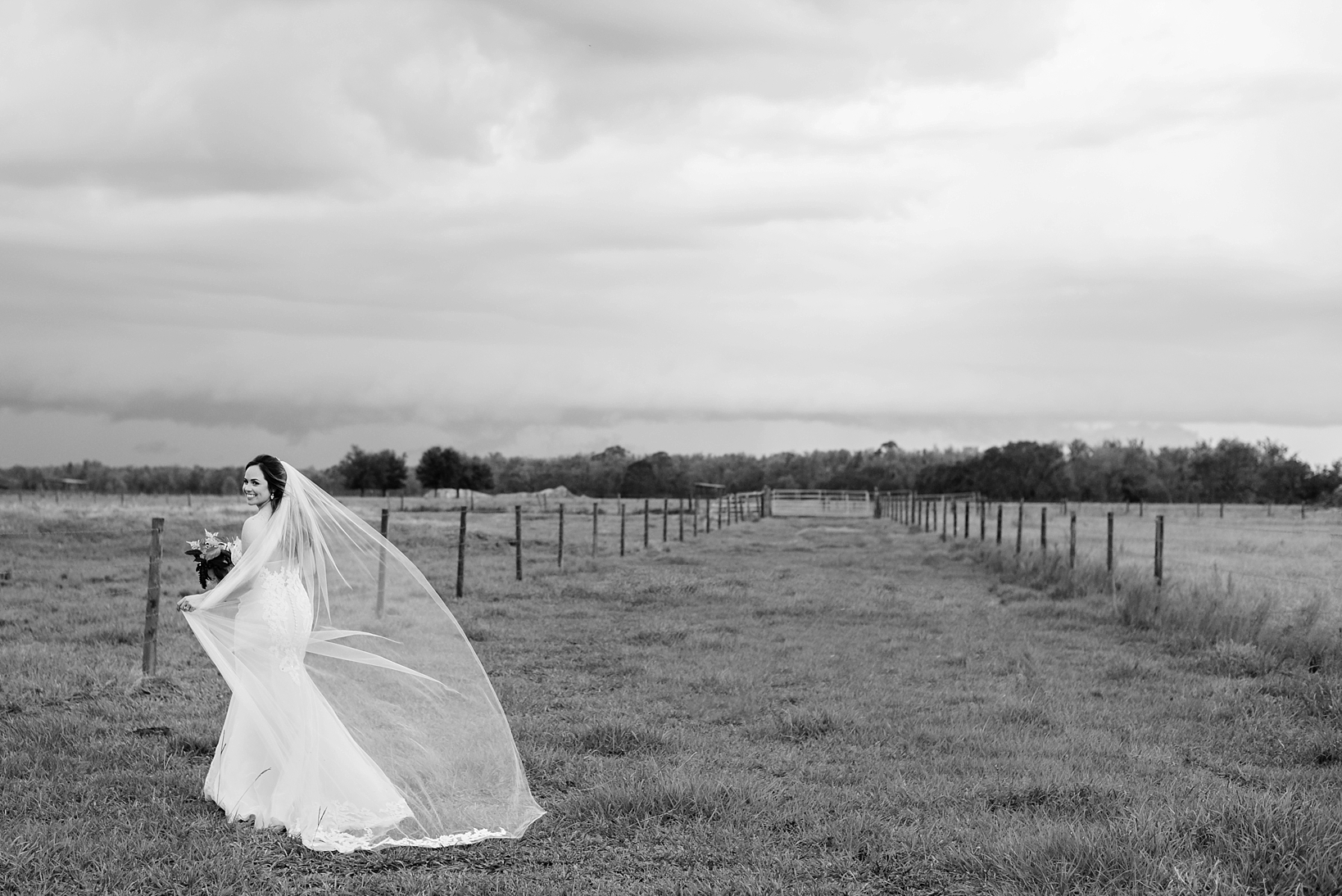 Black and White image of the bride in a field