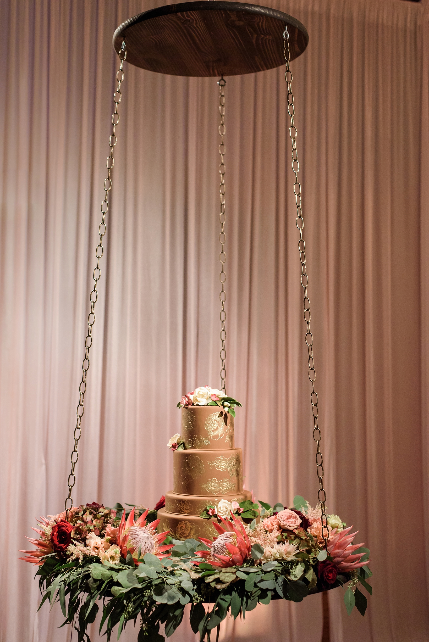 The wedding cake on a swing at the wedding reception