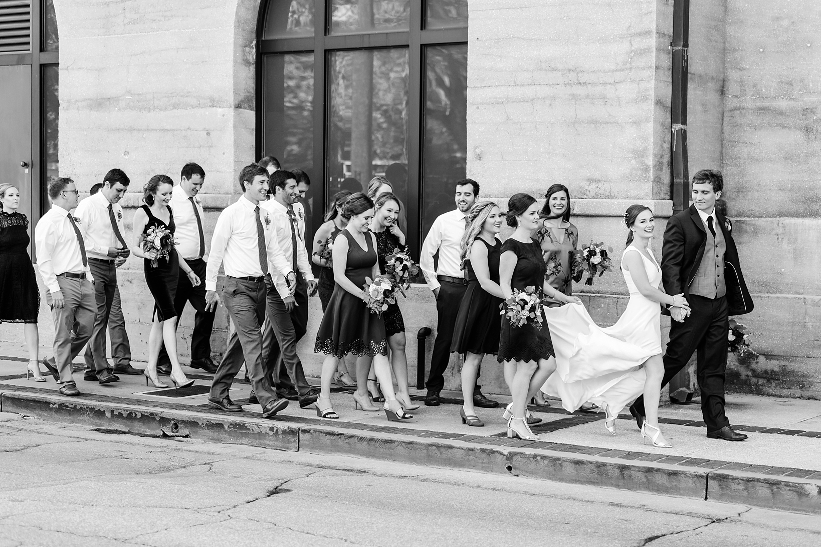 Bridal party walking down the street in St. Augustine, FL by Sarah & Ben Photography