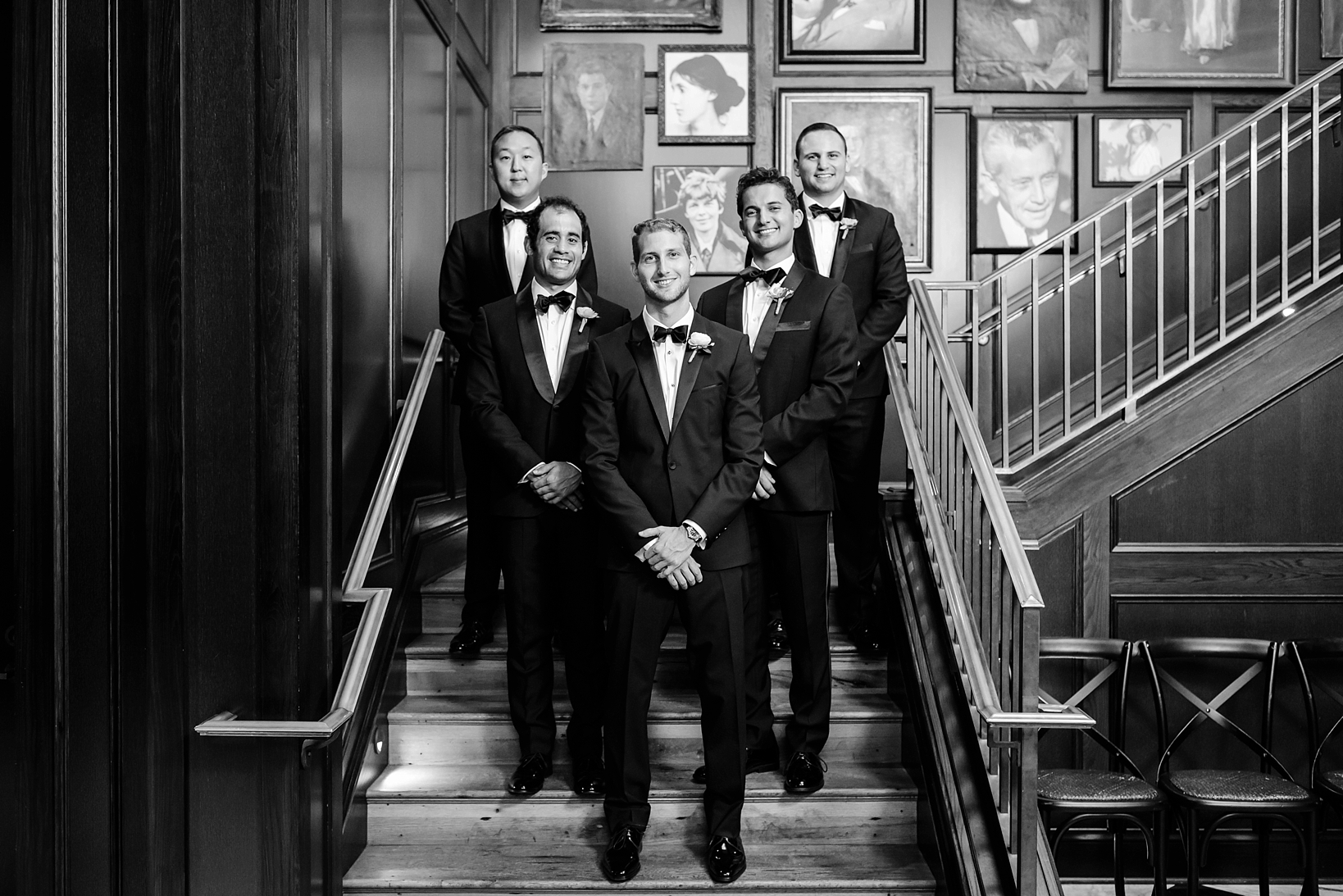 Groom and his Groomsmen in Black and White on the steps of the wedding venue