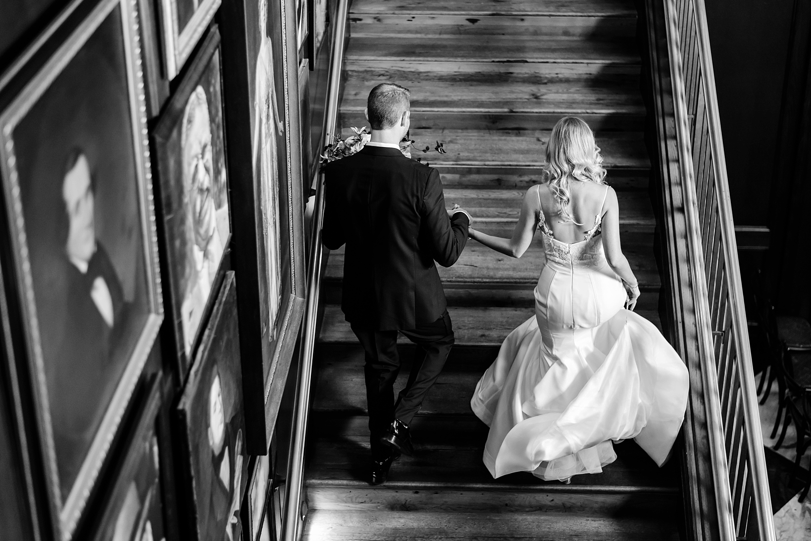 Bride and Groom ascending a staircase at their wedding venue in Tampa, FL