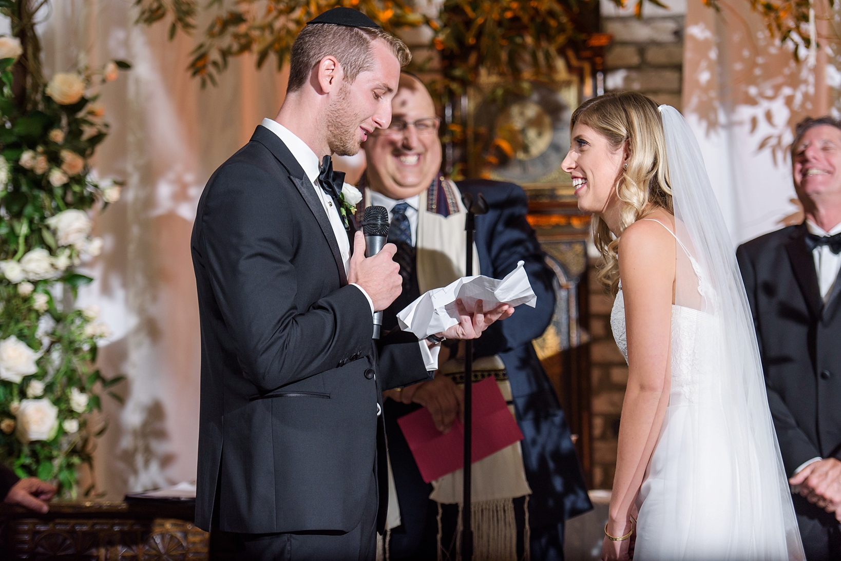 The Groom reads his vows to his smiling Bride