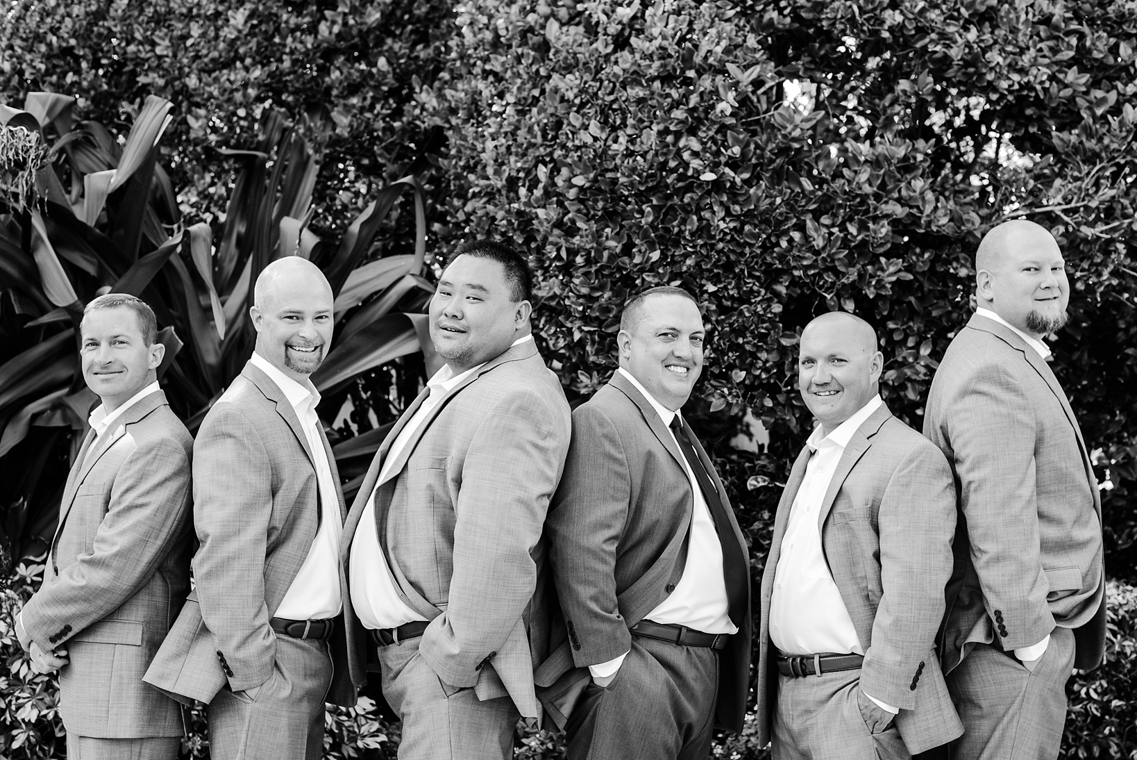 Groom and his Groomsmen strike a pose in black and white