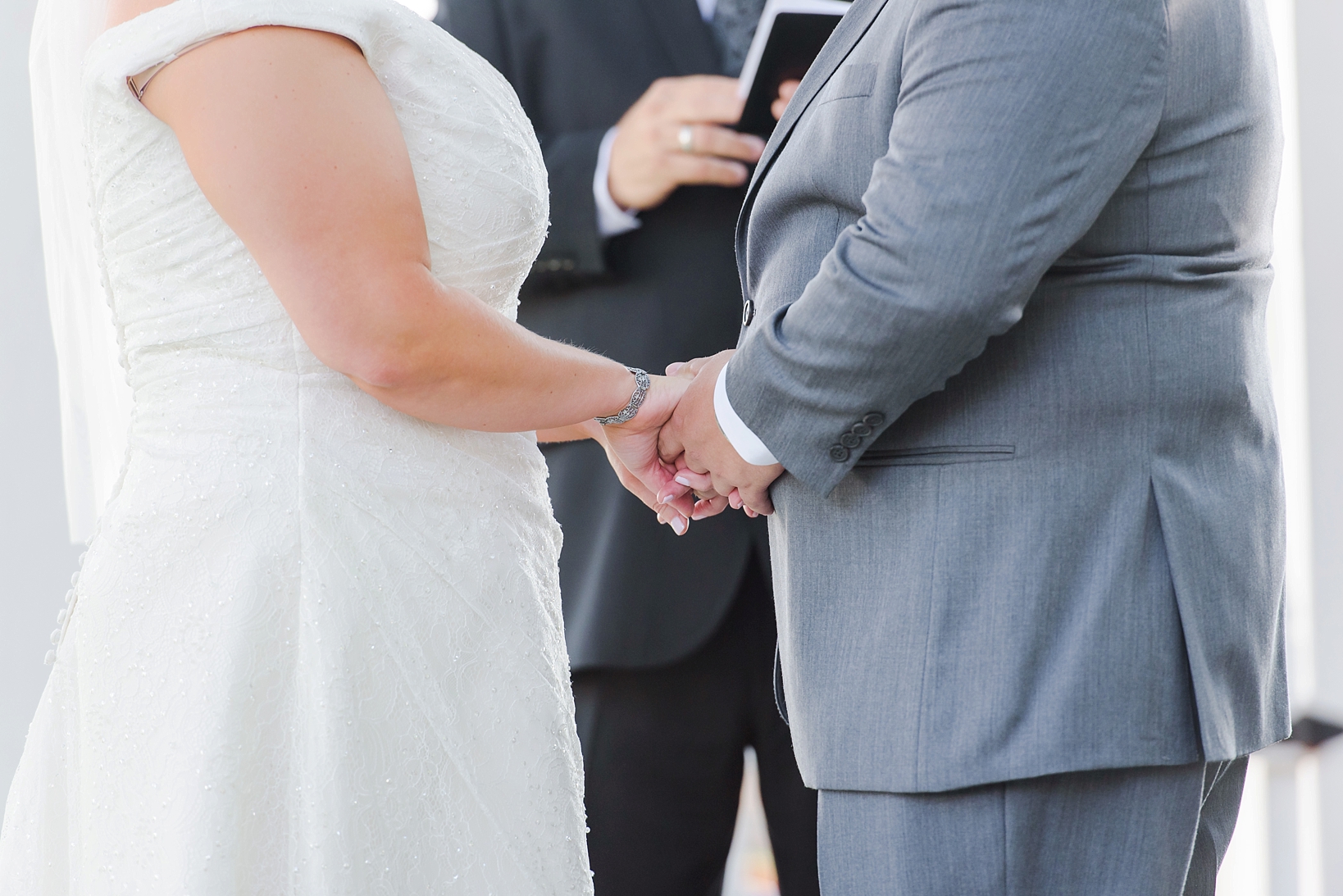 Bride and groom holding hands during their ceremony